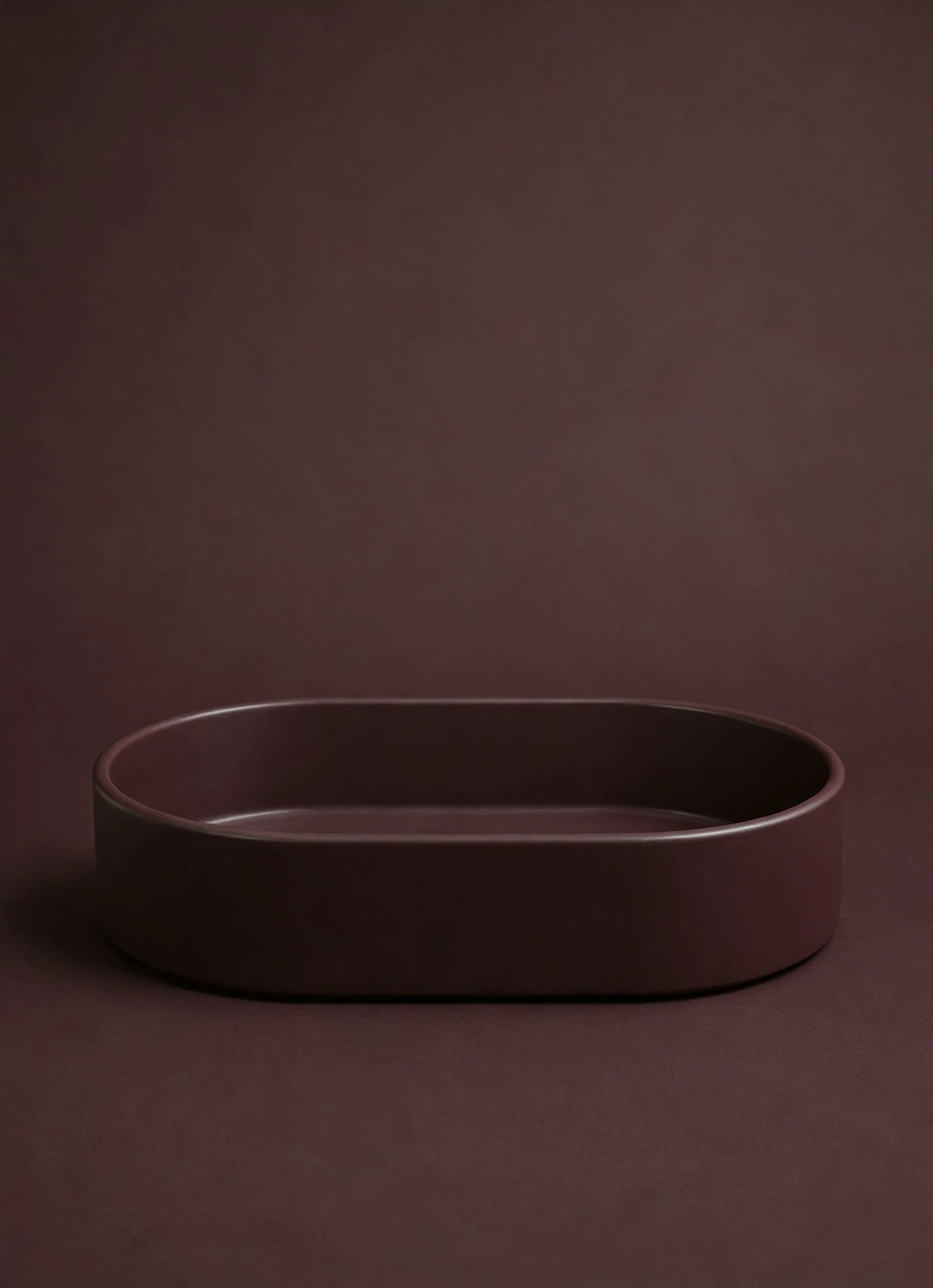 Cimarron oval concrete vessel sink on tonal backdrop