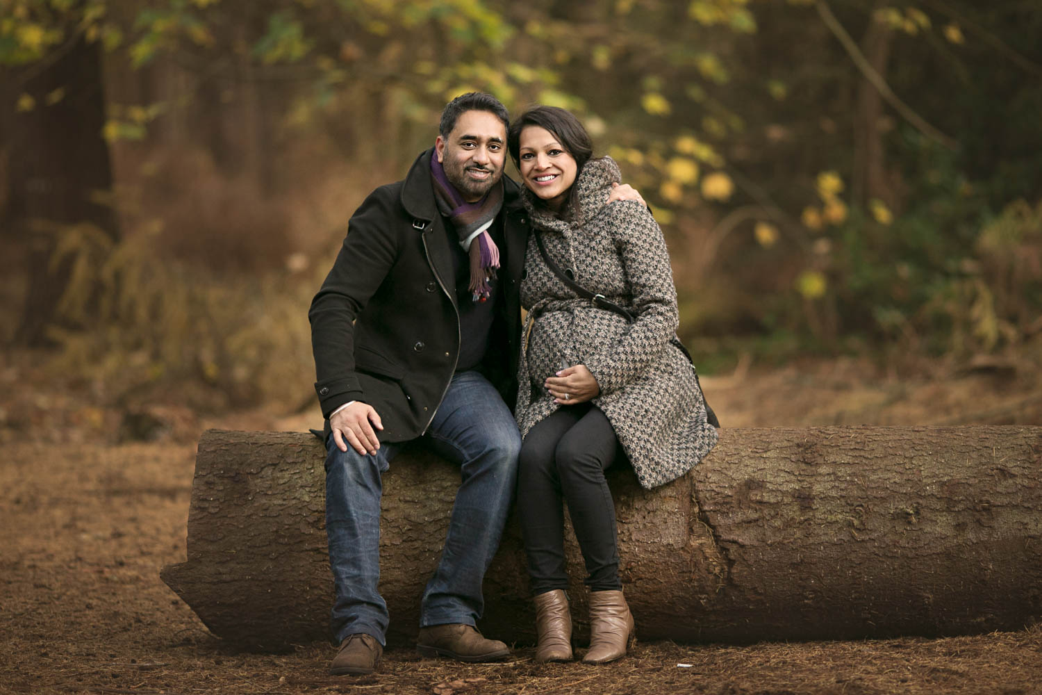  Couple posing on a log during an Autumn photoshoot in Rushmere Park on the Bedfordshire and Buckinghamshire border. 