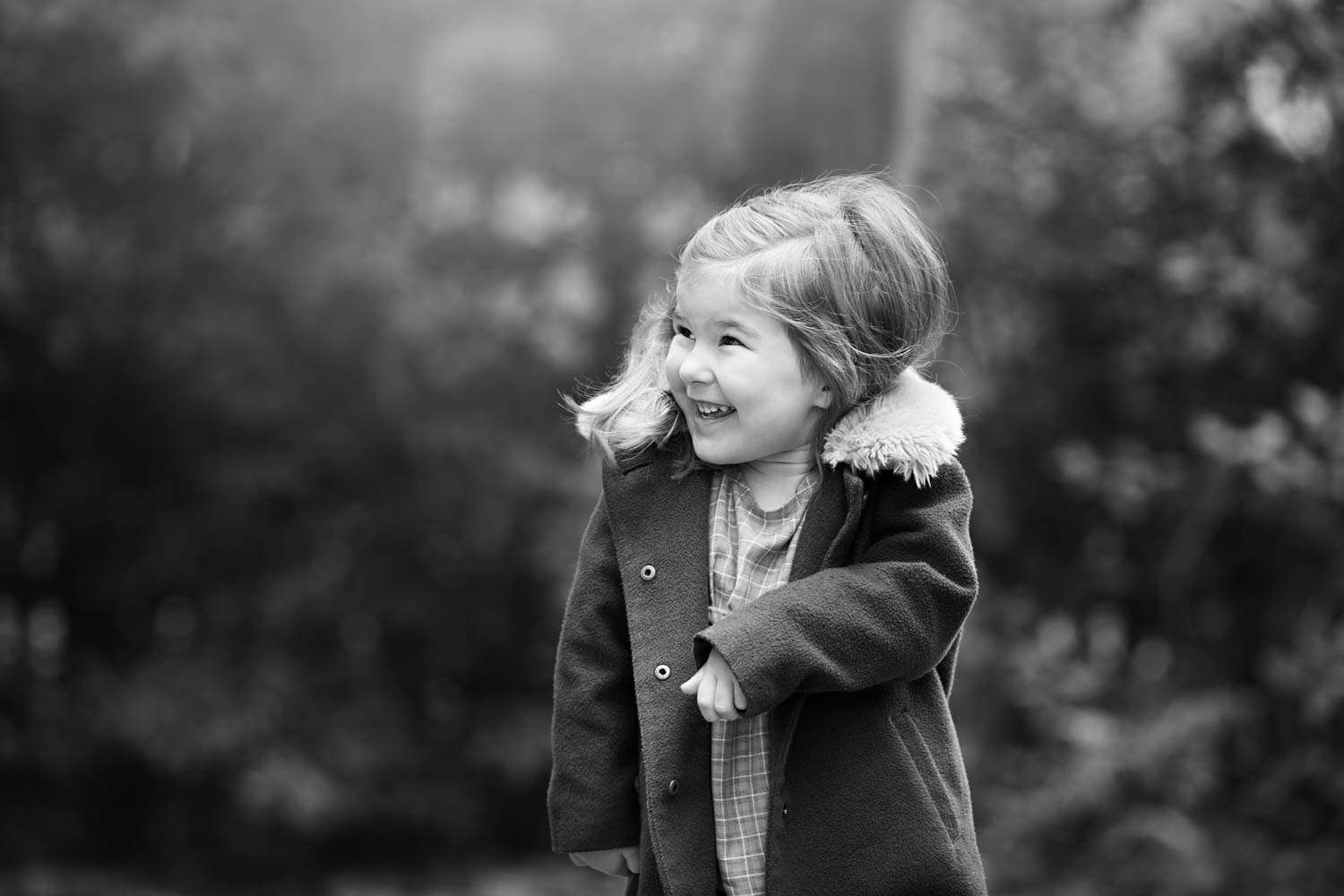  Little girl smiling during a family photoshoot. 