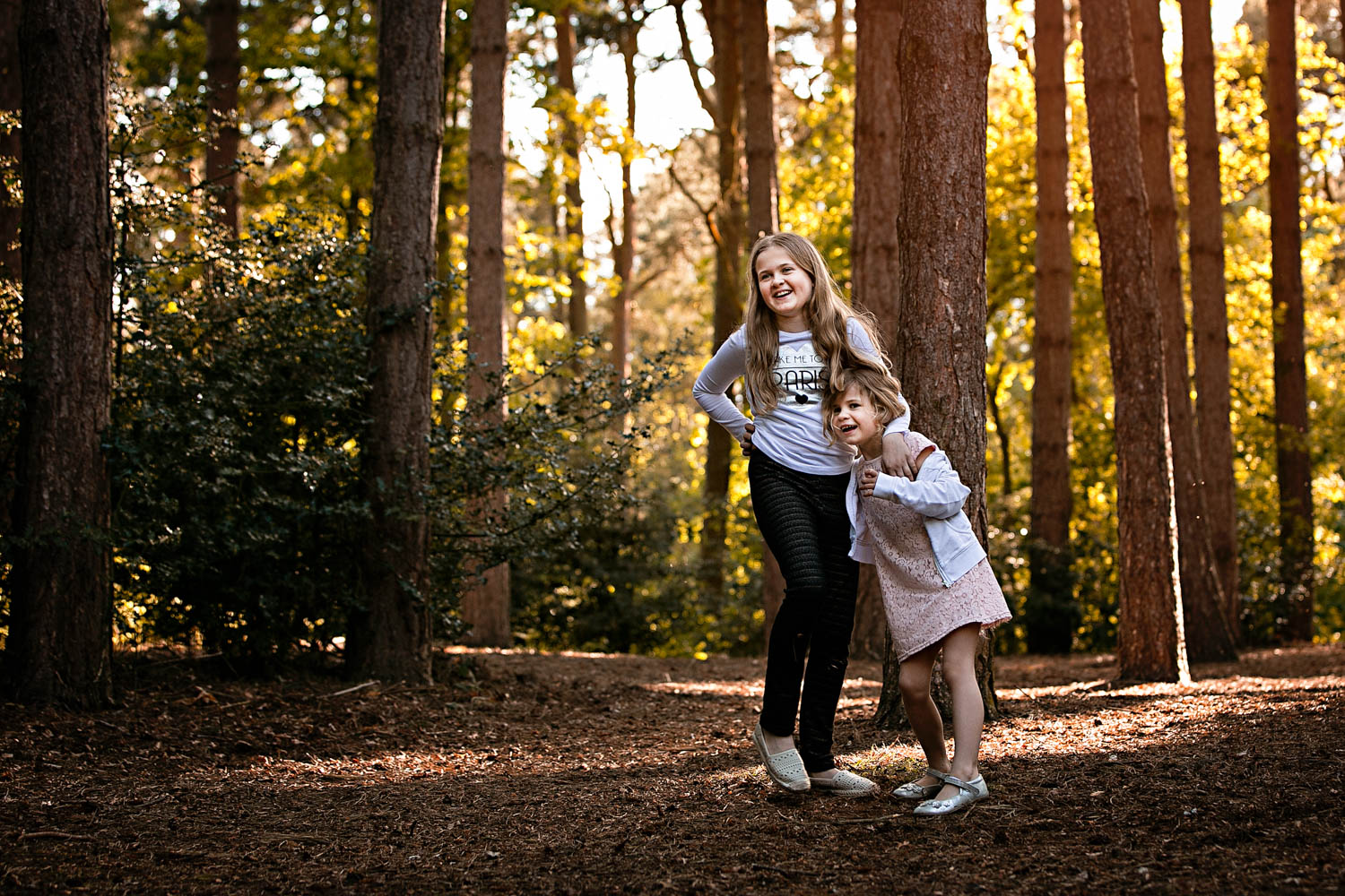  Sisters laughing during a child portrait photography session at Ampthill Park in Bedford. 