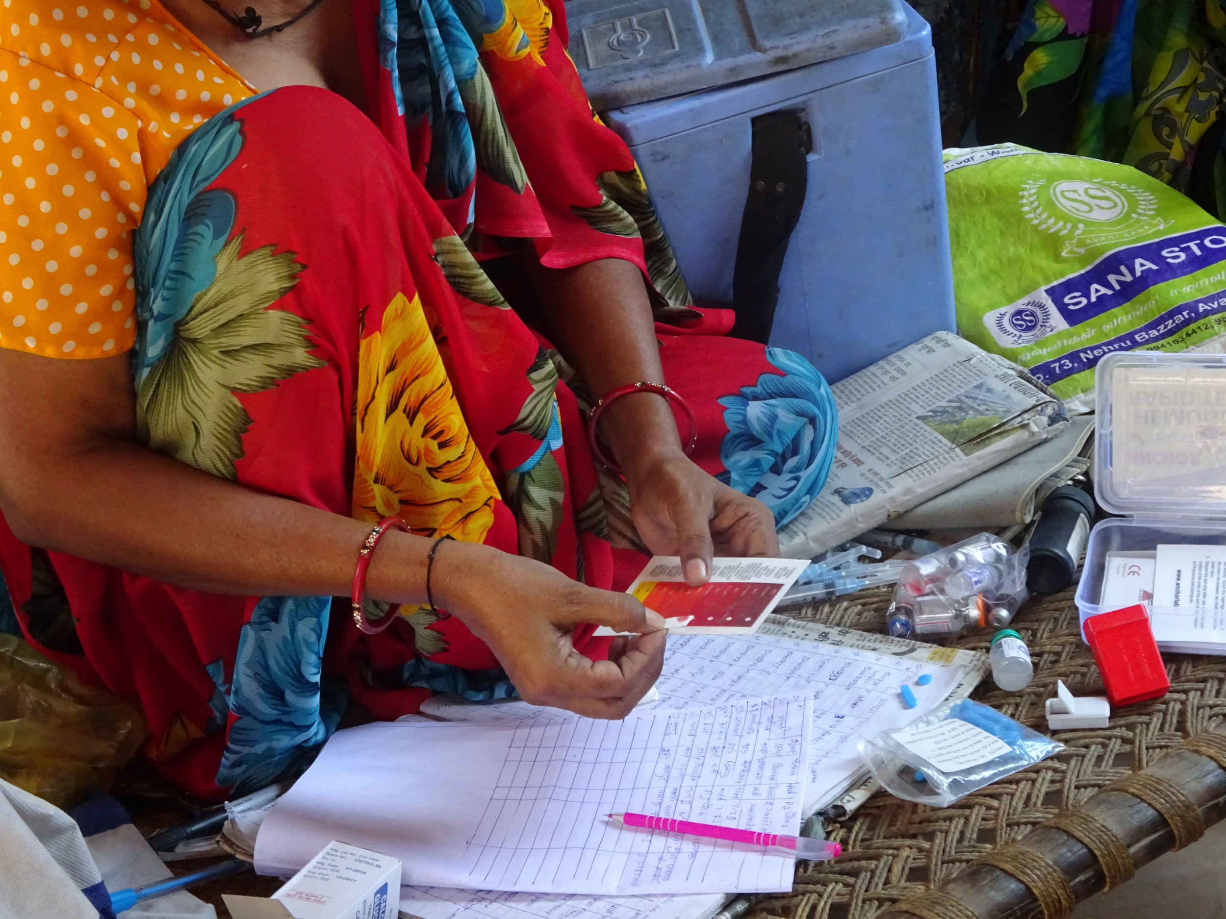 The Village Health Nutrition Day also takes care of child immunization & antenatal chech-ups. Here, an ANM (auxiliary nurse midwife) is conducting a blood test to check for anemia