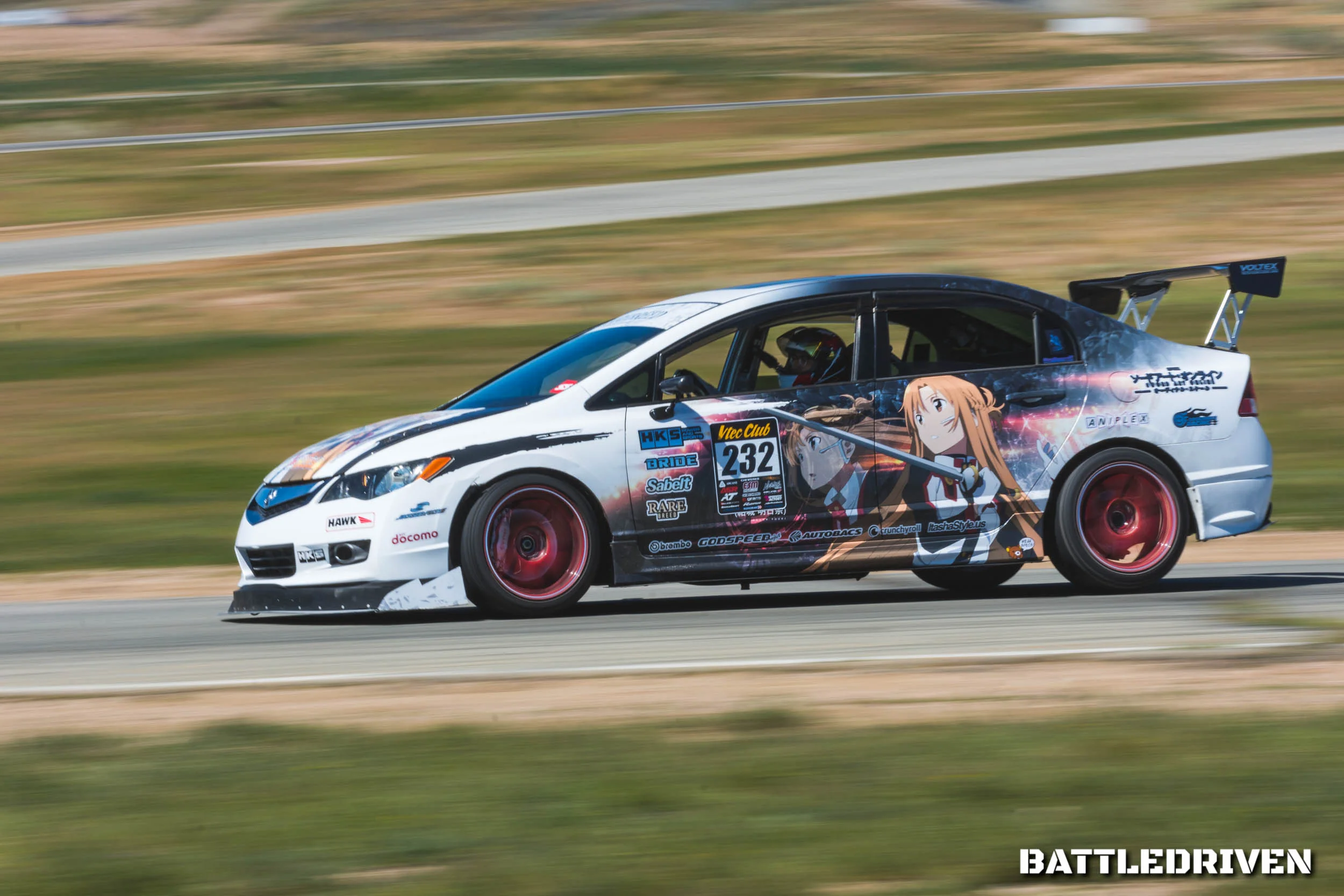 Devyn Bandonillo (@heydevyn) is considered to be one of the leading names in the “Itasha” style movement in the United States. Itasha, literally translated to “painful car” is a style where one dresses their vehicle based on anime or manga characters. Because looking cool in your race car is just as important as going fast in your race car!