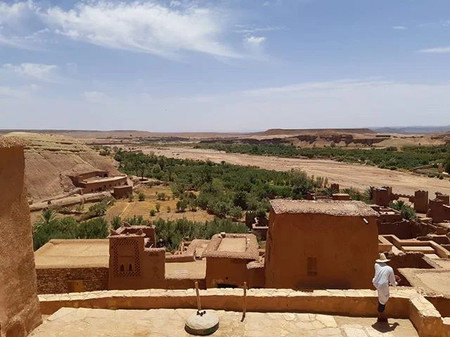 The clay ksar of A&iuml;t-Ben-Haddou overlooks almond groves and the river, now dry under the August sun.