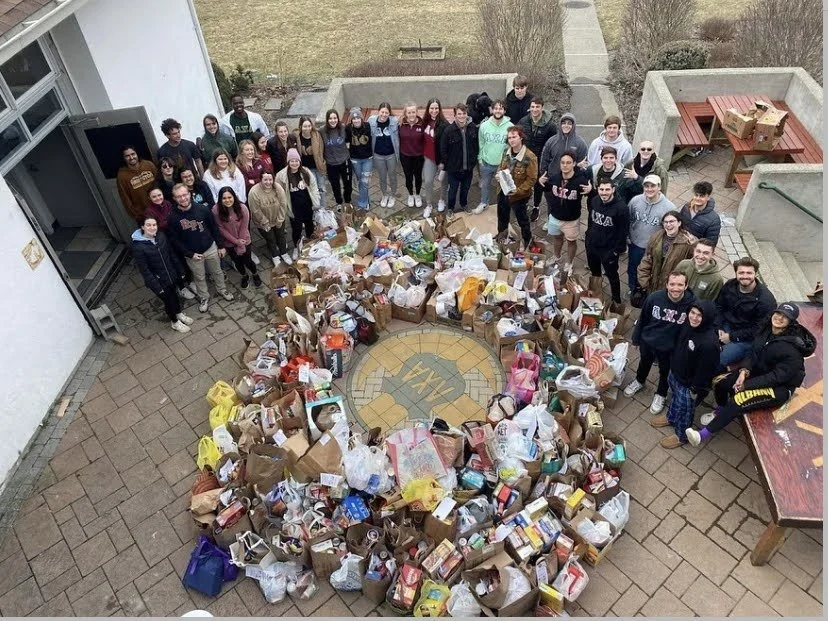 Brothers pose on front porch after a successful LXA run food drive