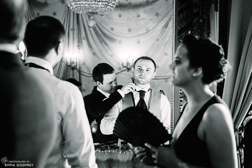 Bestman fixes groom's tie in the mirror of the Palais Eynard