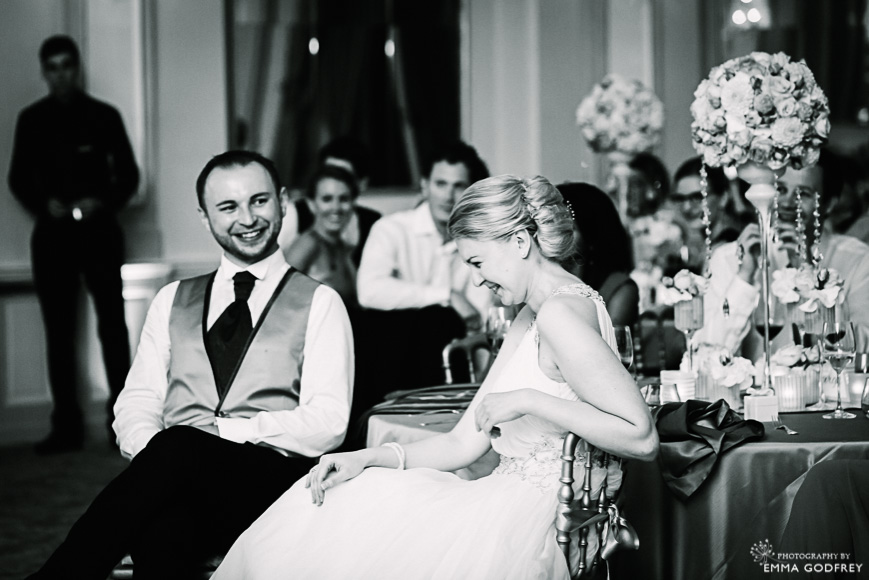 Bride laughs at wedding slideshow