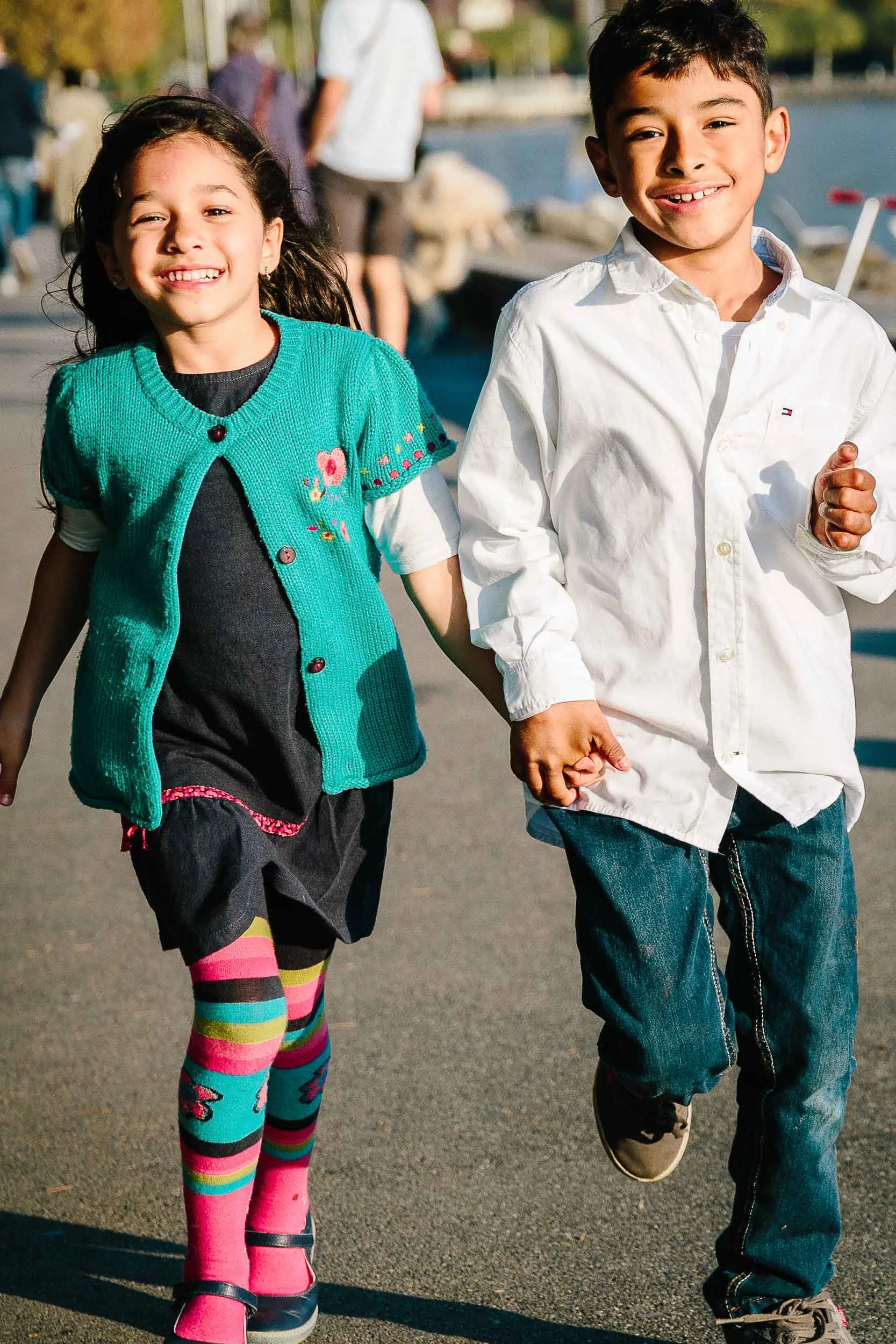 Brother and sister running hand-on-hand