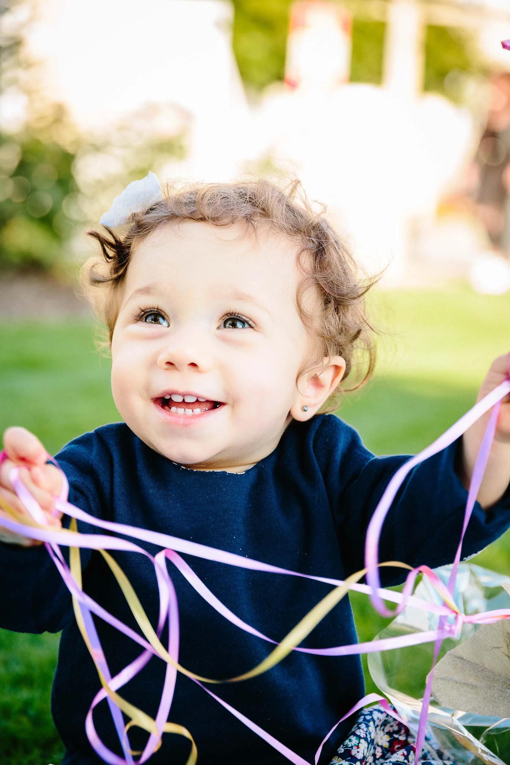 A 1-year-old baby girl enjoying her first birthday shoot and cake smash.