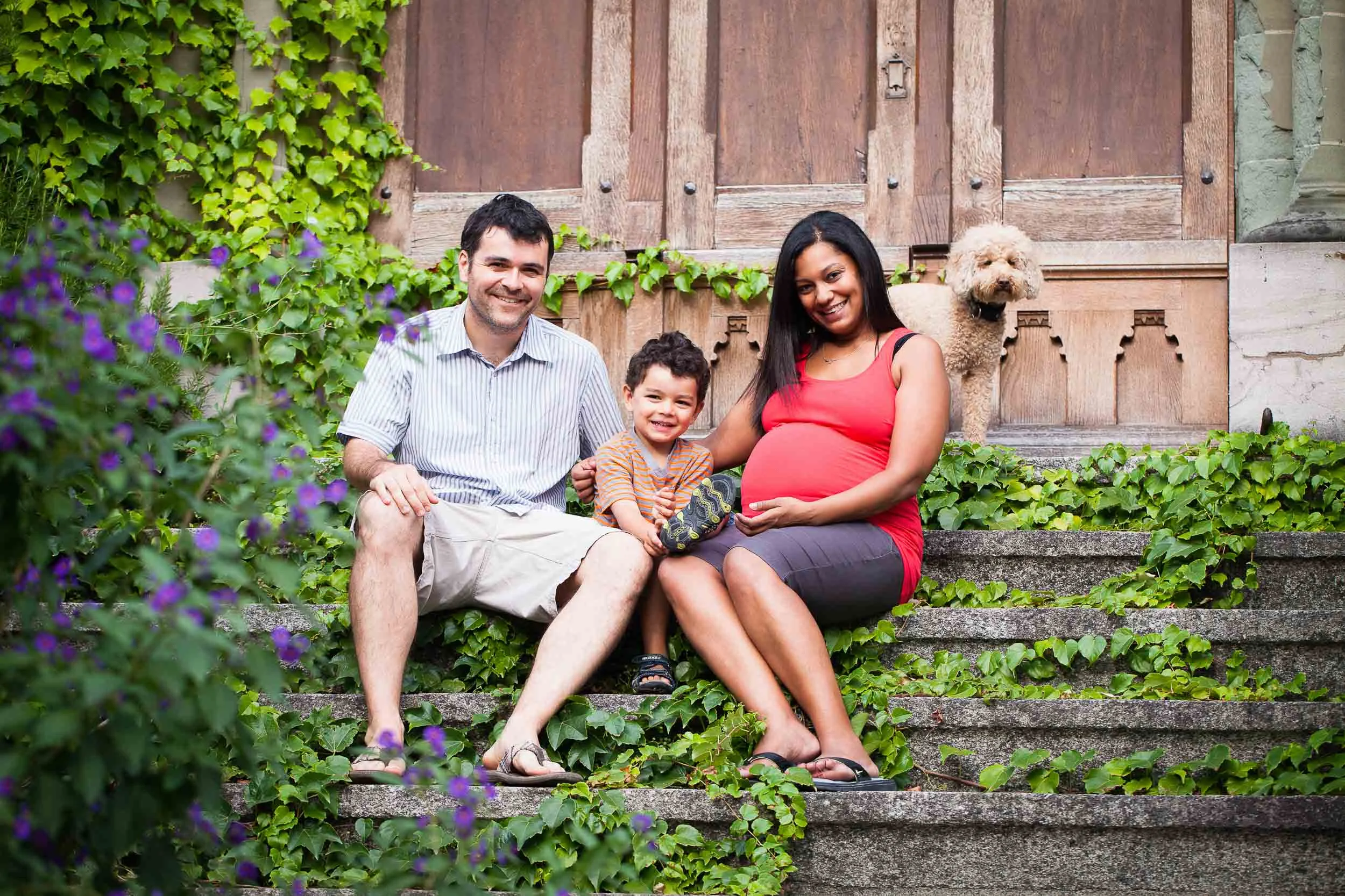 The whole family relaxes on the steps of Cully church for some natural maternity photos