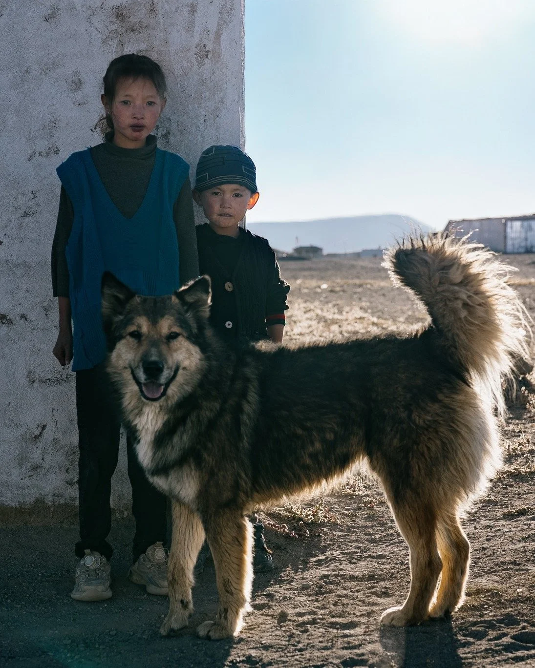 Children of Alichur. 
These two stood steady against the cold wind, their faithful companion by their side. In one of the harshest corners of the planet, they had been aged well beyond their years.