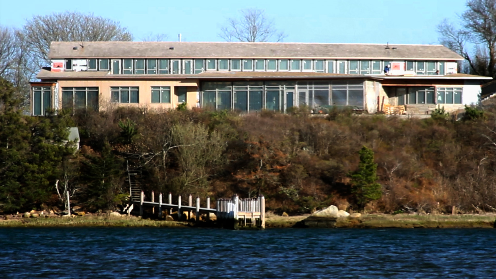 This mega-mansion with accessory buildings (not pictured) replaced an older home overlooking the pond