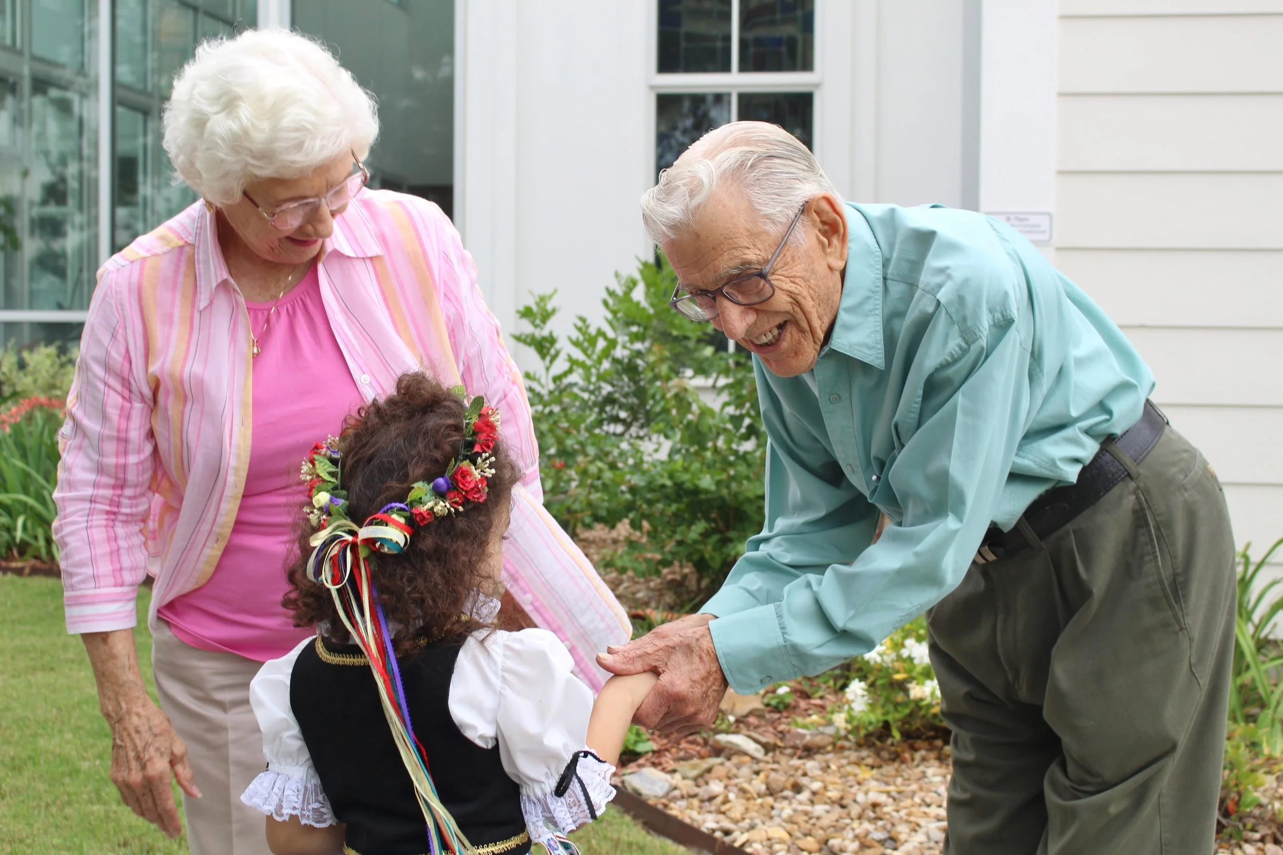 Sanford and Mannie Schmid greet a young visitor to TCHCC Mayfest 2016.