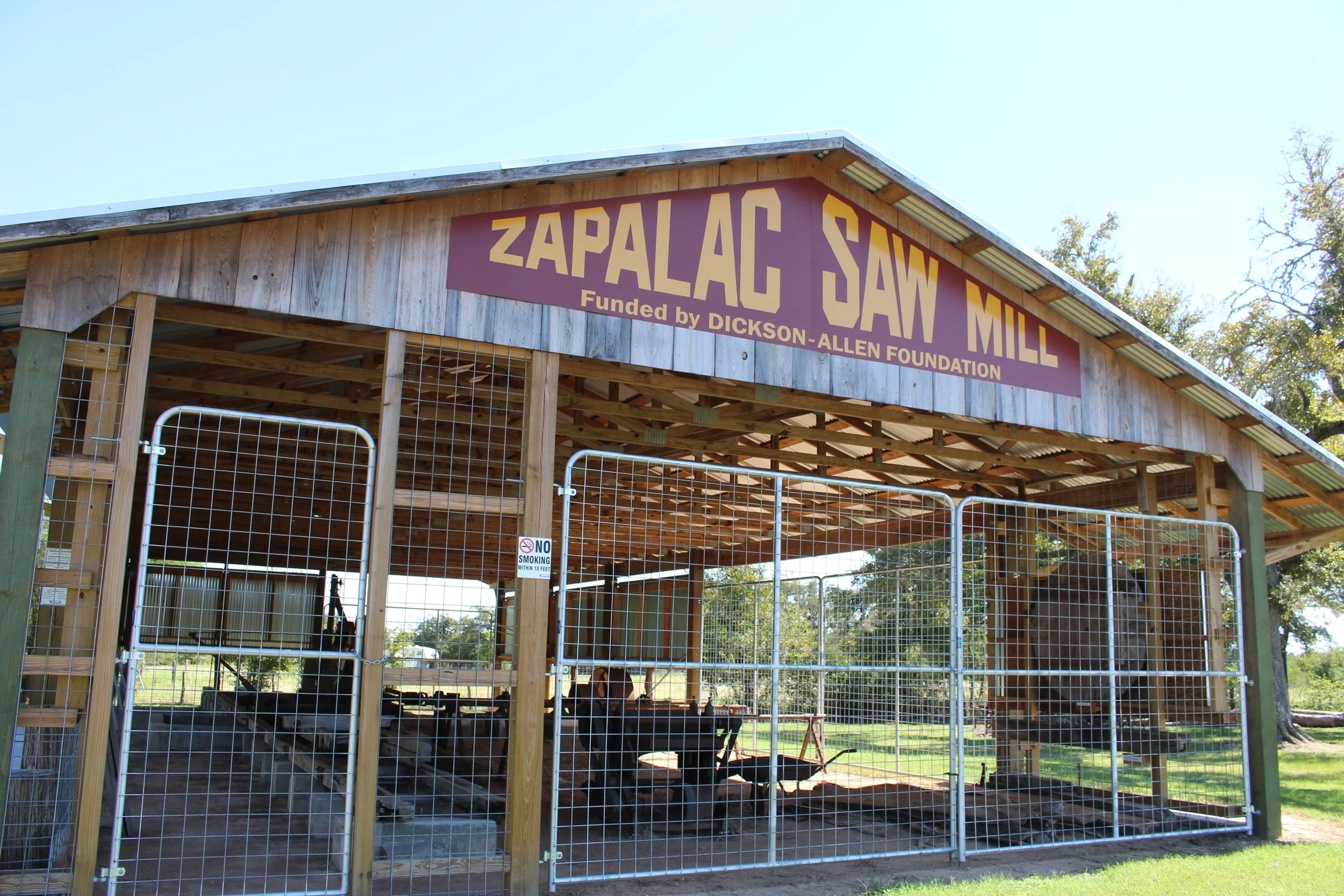This 1895 De Loach No. 1 Mill was owned and operated by the Vinc B. Zapalač family from the Ellinger area on the Colorado River in Fayette County. Donated by Donna Zapalač Mueller, the mill represents the industrial businesses and entrepreneurship of the Czechs. The restoration project was funded by a grant from the Dickson-Allen Foundation along with various versions of help from others. The mill restoration was completed in 2015, and is a working original maintained by the South Texas Wheel Spinners & Crank Twisters Antique Farm Equipment Club. The display also showcases early life on the Zapalač family farm. The mill is operated at the May Fest and Heritage Fest each year and on school tours.