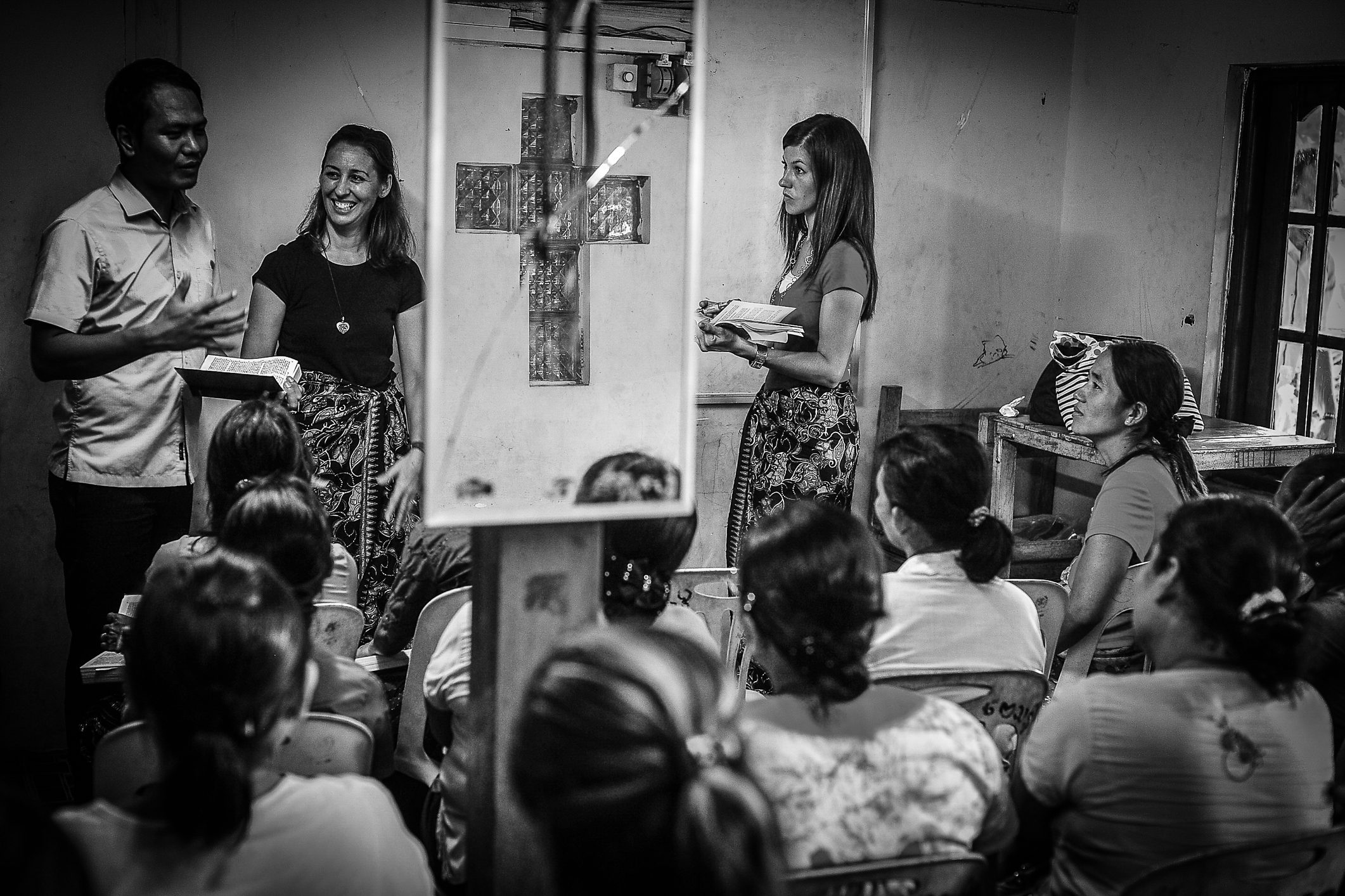 Man speaking to group of women about experiential education.