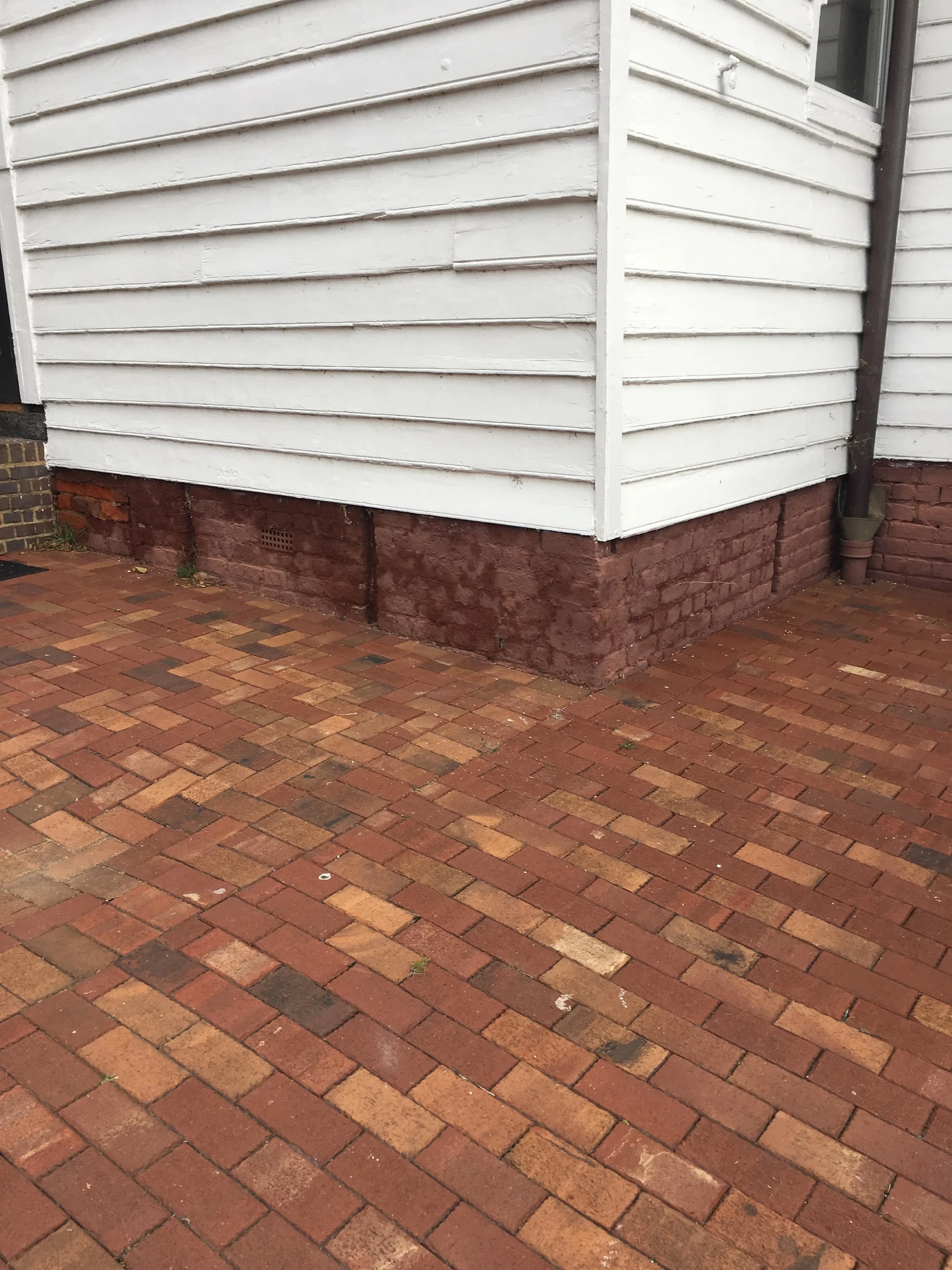 Red paint on the foundation hides underlying decay.