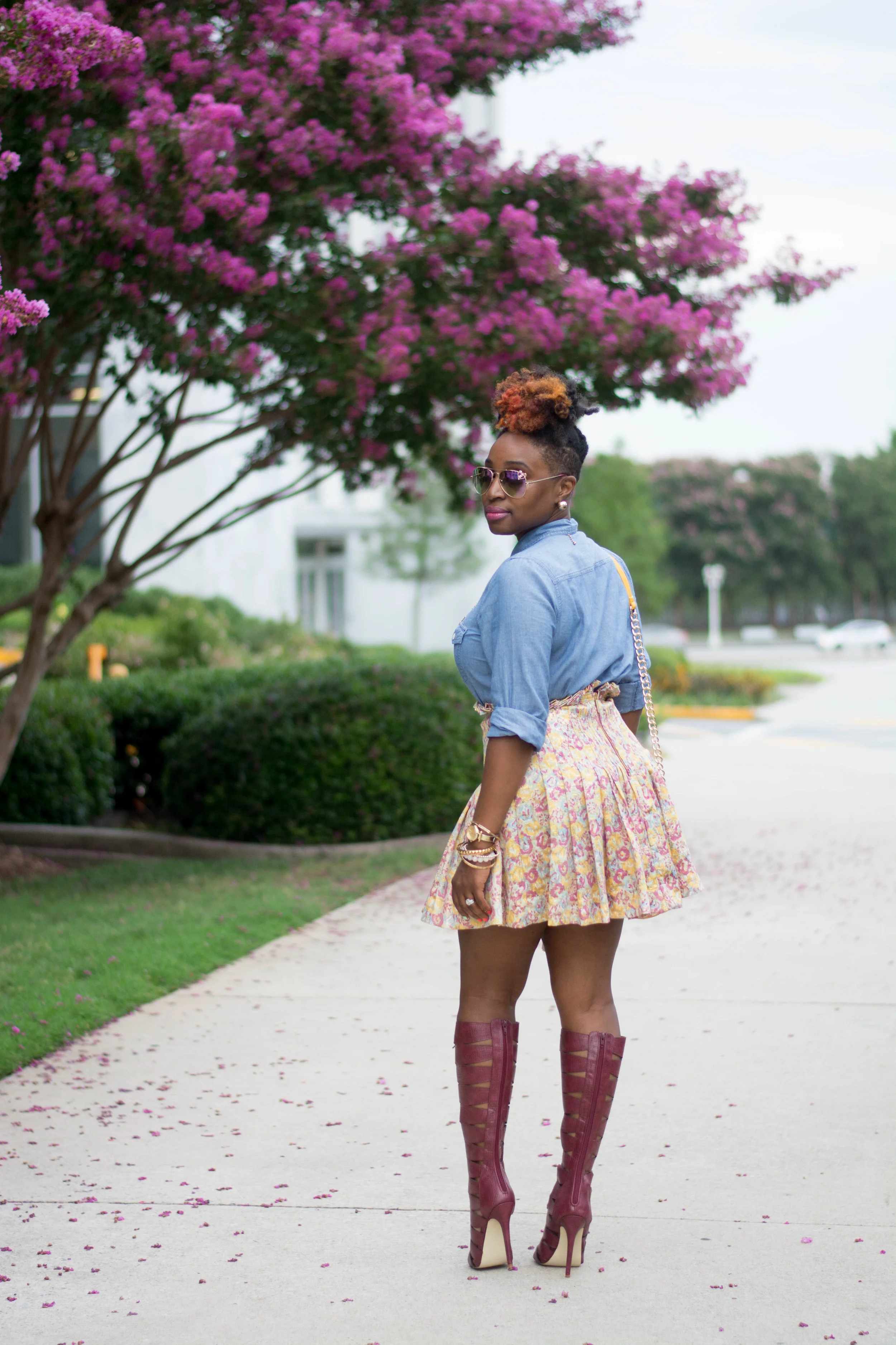 Atlanta stylist wearing a chambray top and floral mini skirt with tall Bordeaux lace up boots