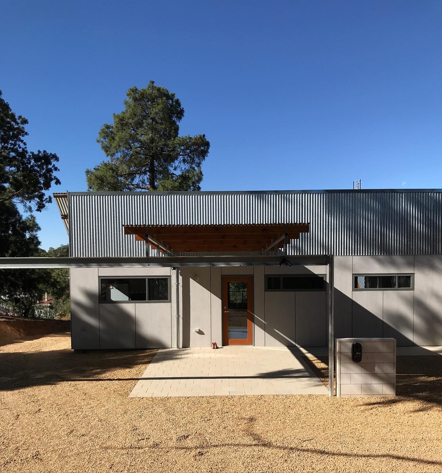 Angaston Hill. Rear elevation.  A cluster of dwellings.  Predominantly self finished materials.  Level access. Car charger at the ready.  Red boots at the back door.  Built with exceptional attention to detail by Bartsch Builders.