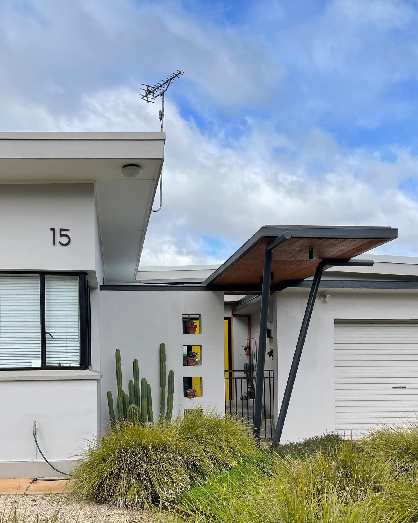 We recently revisited our Mid-century  Modest project. We love  that the new canopy (and entry) is working exactly as it was designed to do. 
It ties together the old and new, respecting snd framing the existing. It give a strong and lively street pr