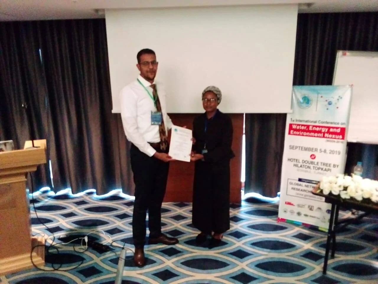 Aisha being awarded a certificate for chairing a technical session on water and wastewater