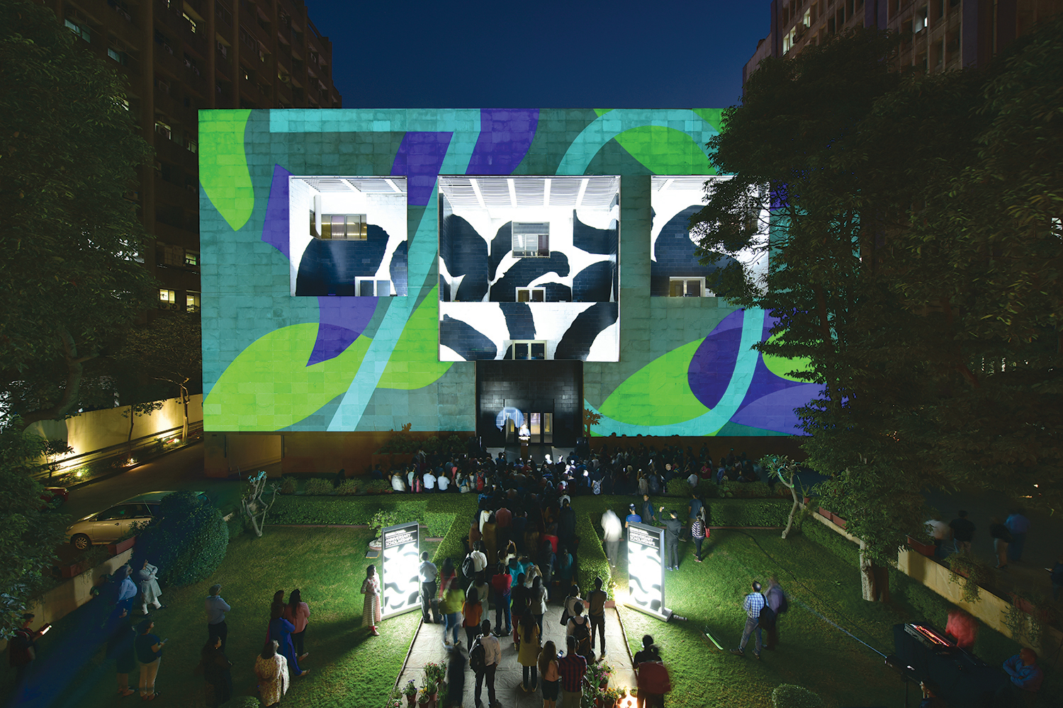 The identity uses this pattern language across a broad scope of materials and platforms, including projections, physical merchandise, social media, concert backdrops and certificates.