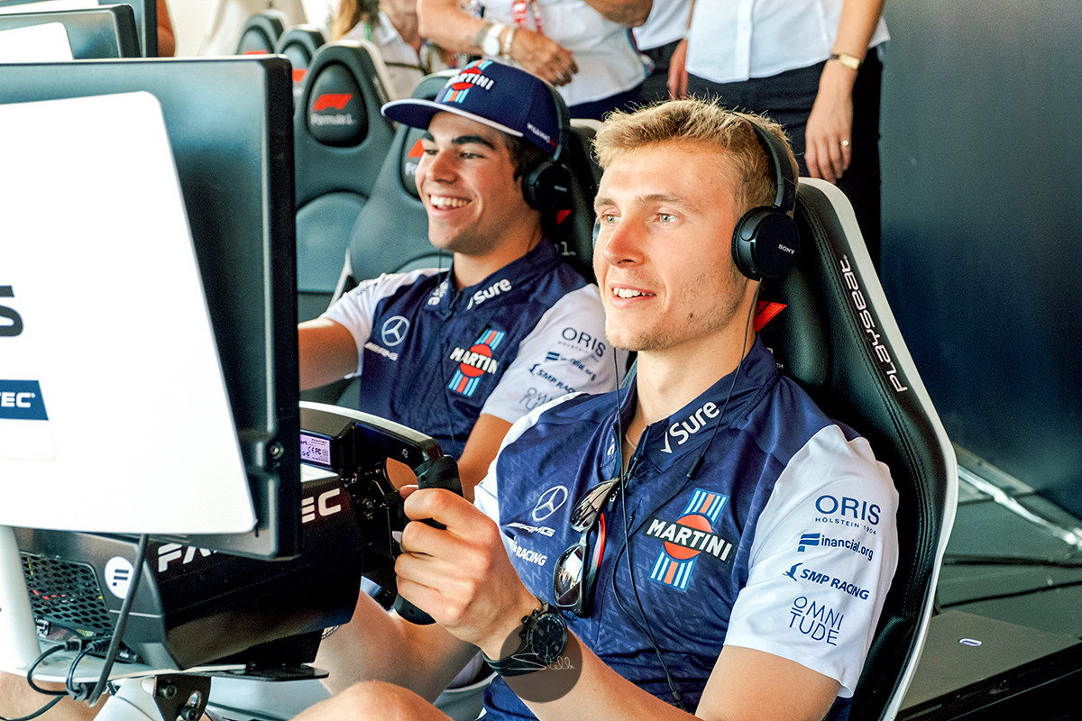  Sergey and his team-mate Lance go head-to-head on the simulators in the F1 Fan Zone 
