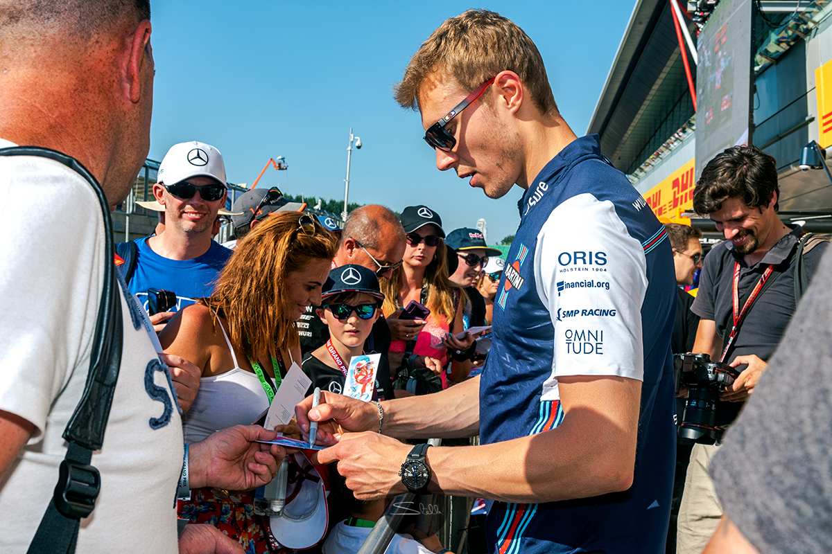  Sergey meets the fans for an autograph signing session in the Silverstone pitlane 