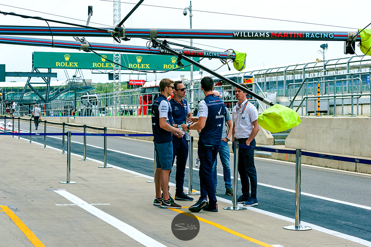  Sergey and his engineers chat in the pitlane 