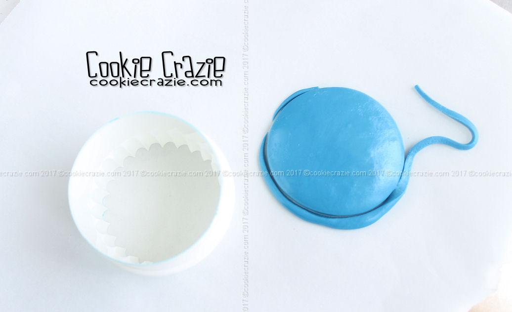Form a flattened yet domed piece of "dough" and lay it on parchment paper. Cut it out with a circle cutter (the size that will fit best on the main part of the tombstone/horseshoe cookie).