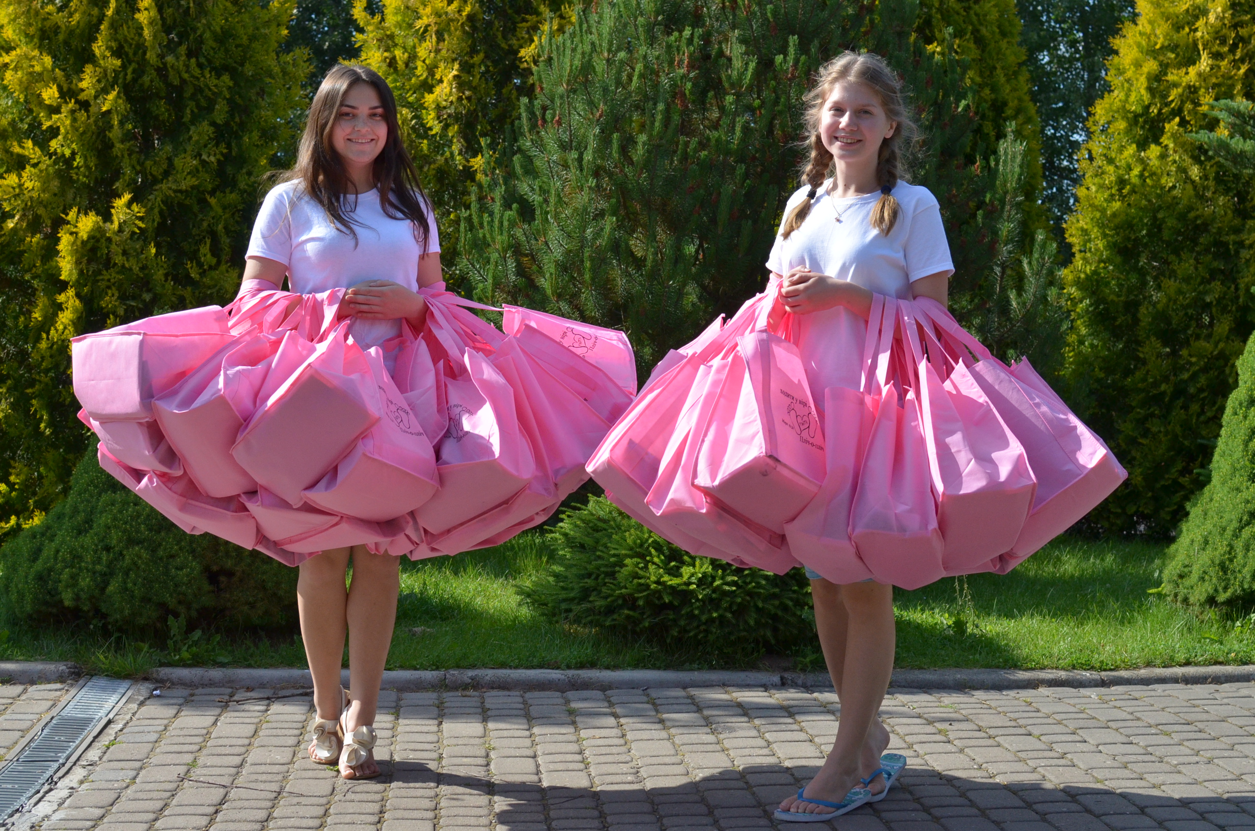  Each lady received a bright pink bag filled with lots of goodies. Here's two of the awesome workers who collected up all the bags to hand out to the women on the first day. (Isn't it cool how the bags create a pretty skirt effect on each of the girl