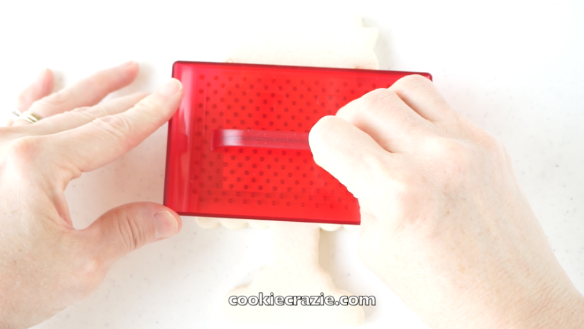  Allow the glaze to dry for at least 2 hours and then press this  polka dot impression tool  into the partially dried glaze. 
