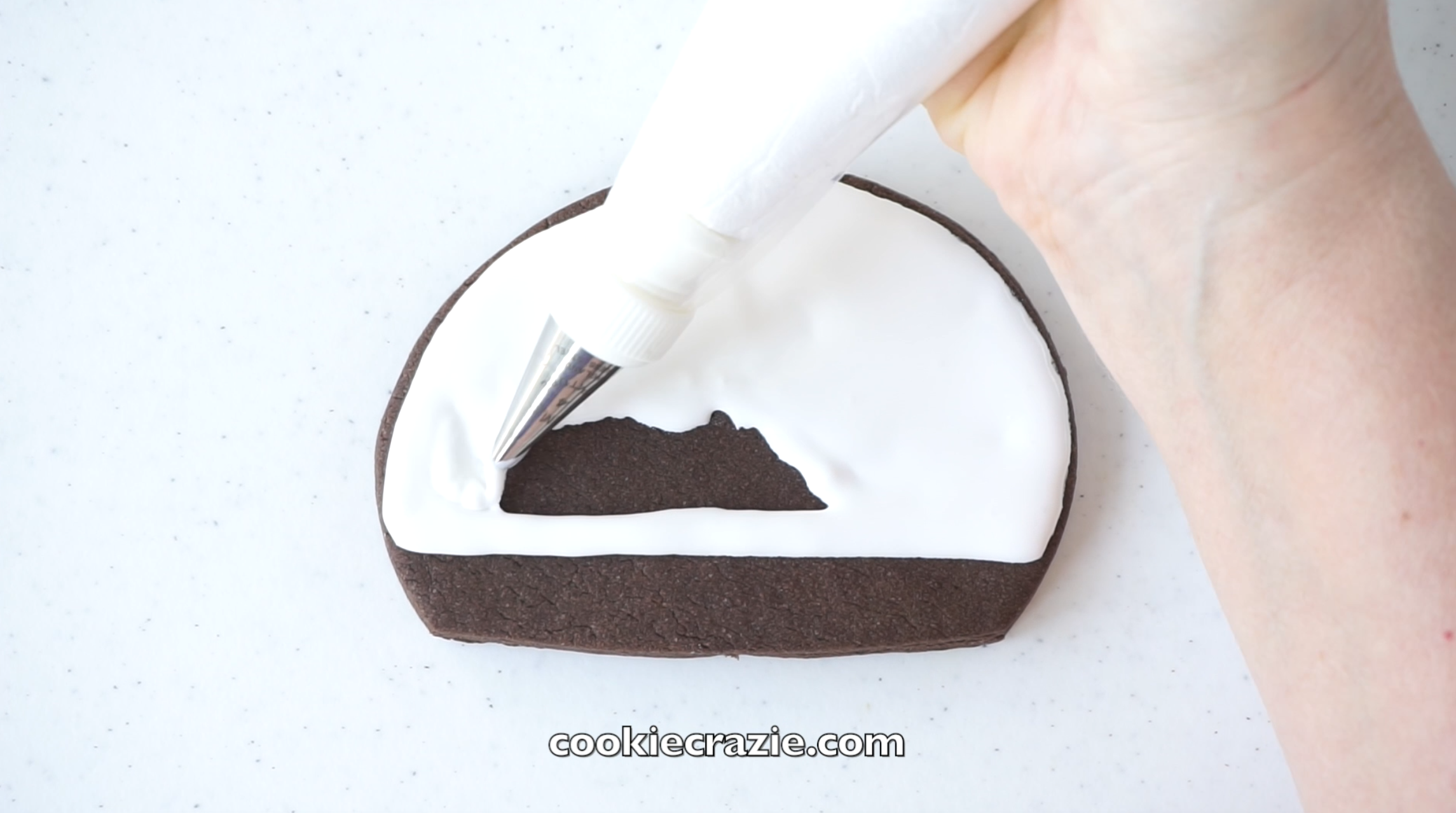 Outline and flood the entire head of the snowman with white glaze.