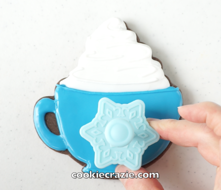  When the timer that you set [after flooding the base of the mug] goes off, use a plunger/cutter like  THIS ONE &nbsp;or  THIS ONE  or a mini cookie cutter to emboss the front of the mug as shown on the photos/video. 