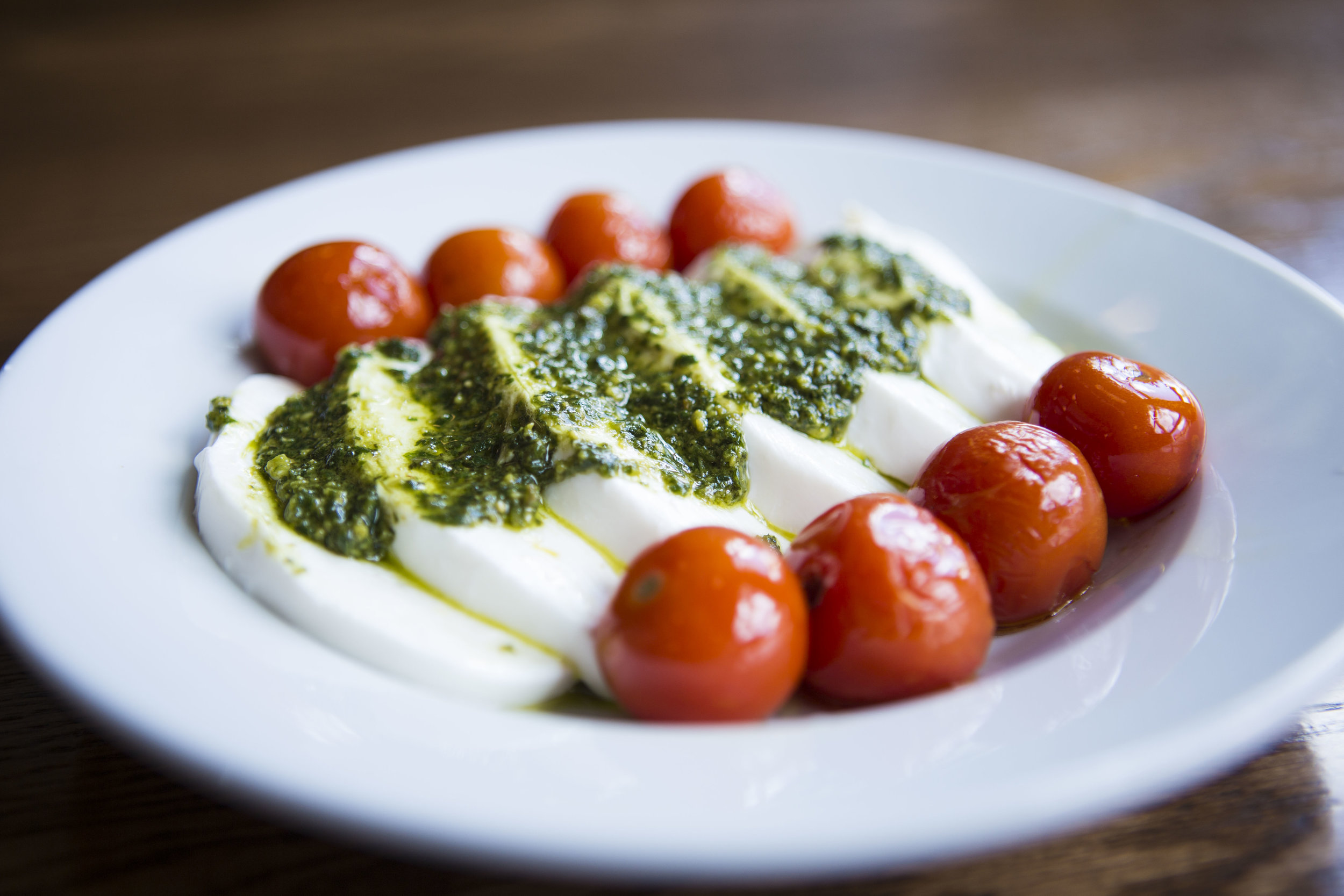  Caprese salad with tomato, basil, pesto, fresh mozzerella, olive oil, sea salt and cracked pepper at Pizza Brutta on May 17, 2016 in Middleton, WI.&nbsp; 