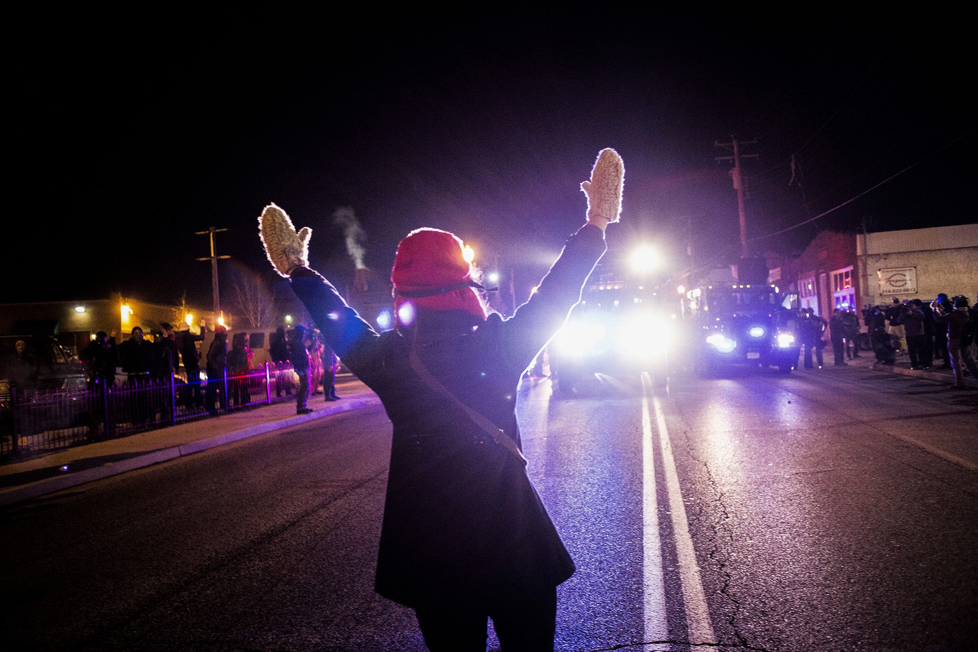  A protester stands in front of authorities saying "hands up, don't shoot" on Nov. 25, 2014 in Ferguson, MO. 