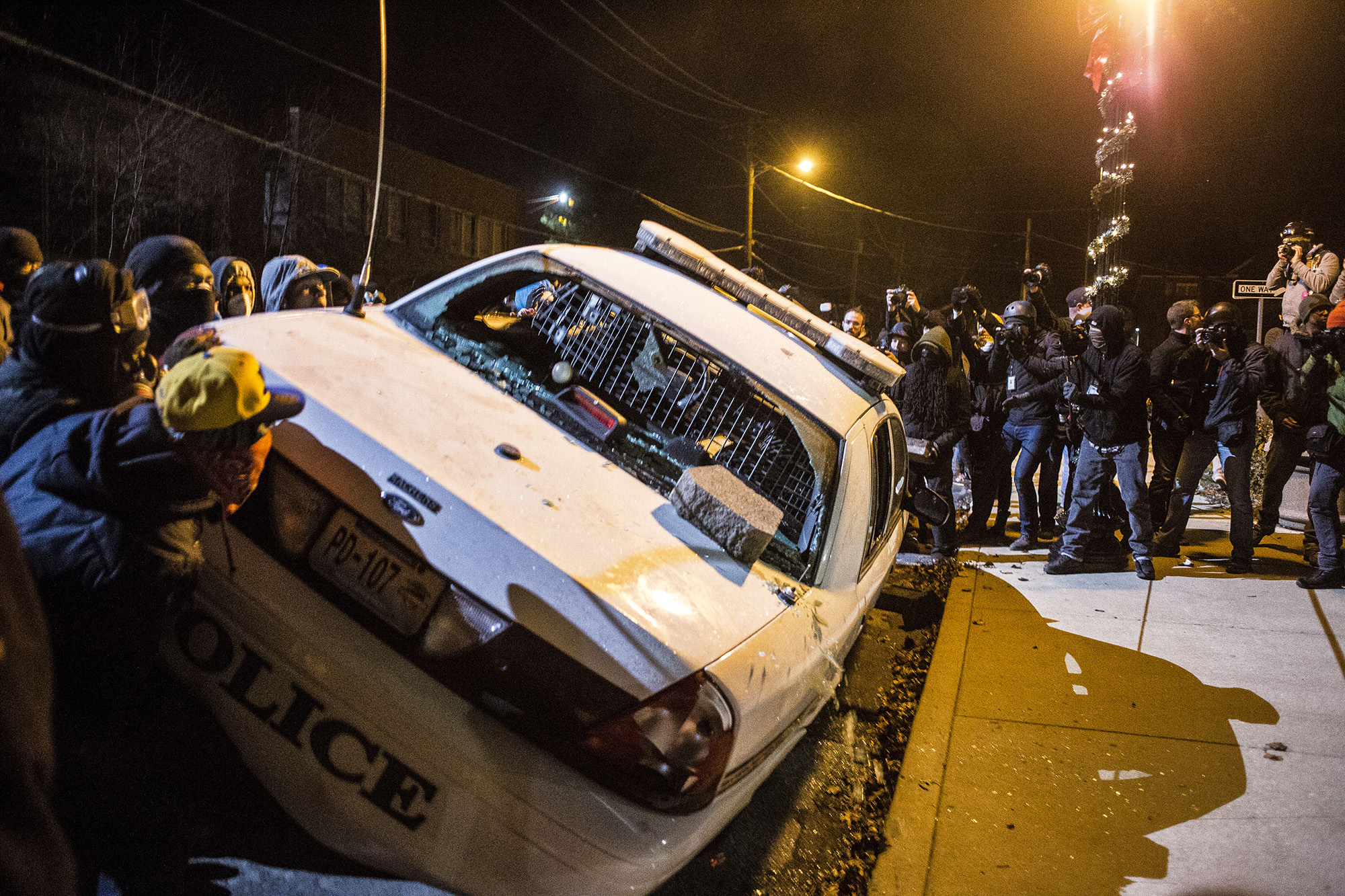  Protesters vandalize a police vehicle outside the Ferguson City Hall on Nov. 25, 2014 in Ferguson, MO.&nbsp; 