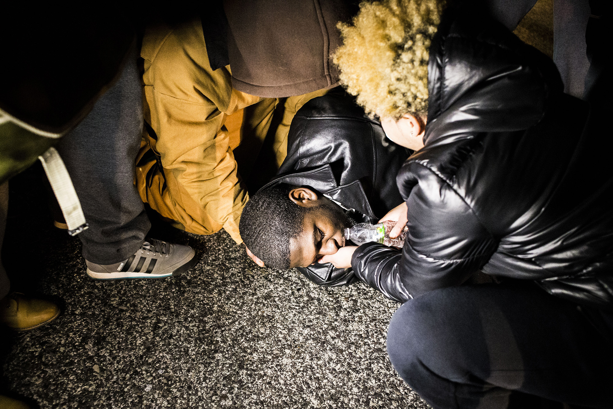  A protester lays on the street after police sprayed him with tear gas on Nov. 24, 2014, Ferguson, MO. 