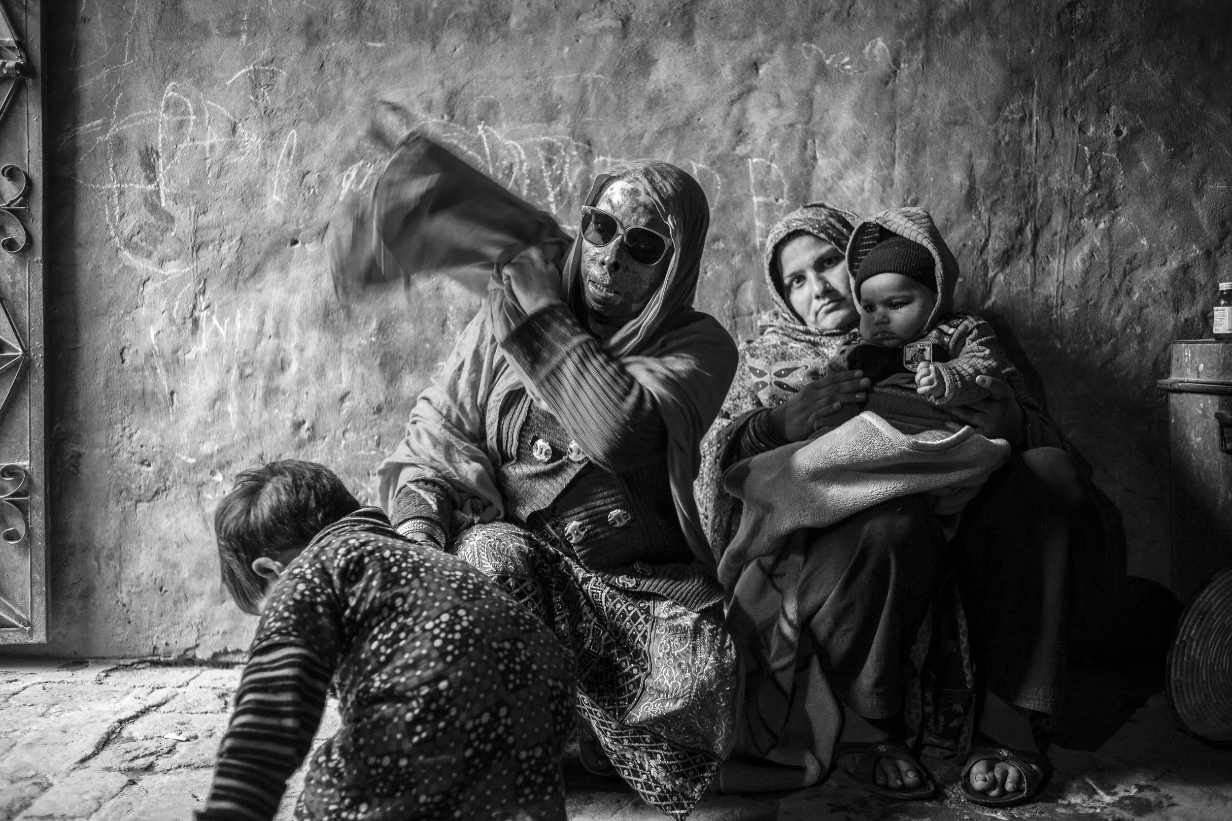  Sarwari Bibi with her sister-in-law and nephew at their residence on Jan. 23, 2016 in Lahore, Pakistan. 
