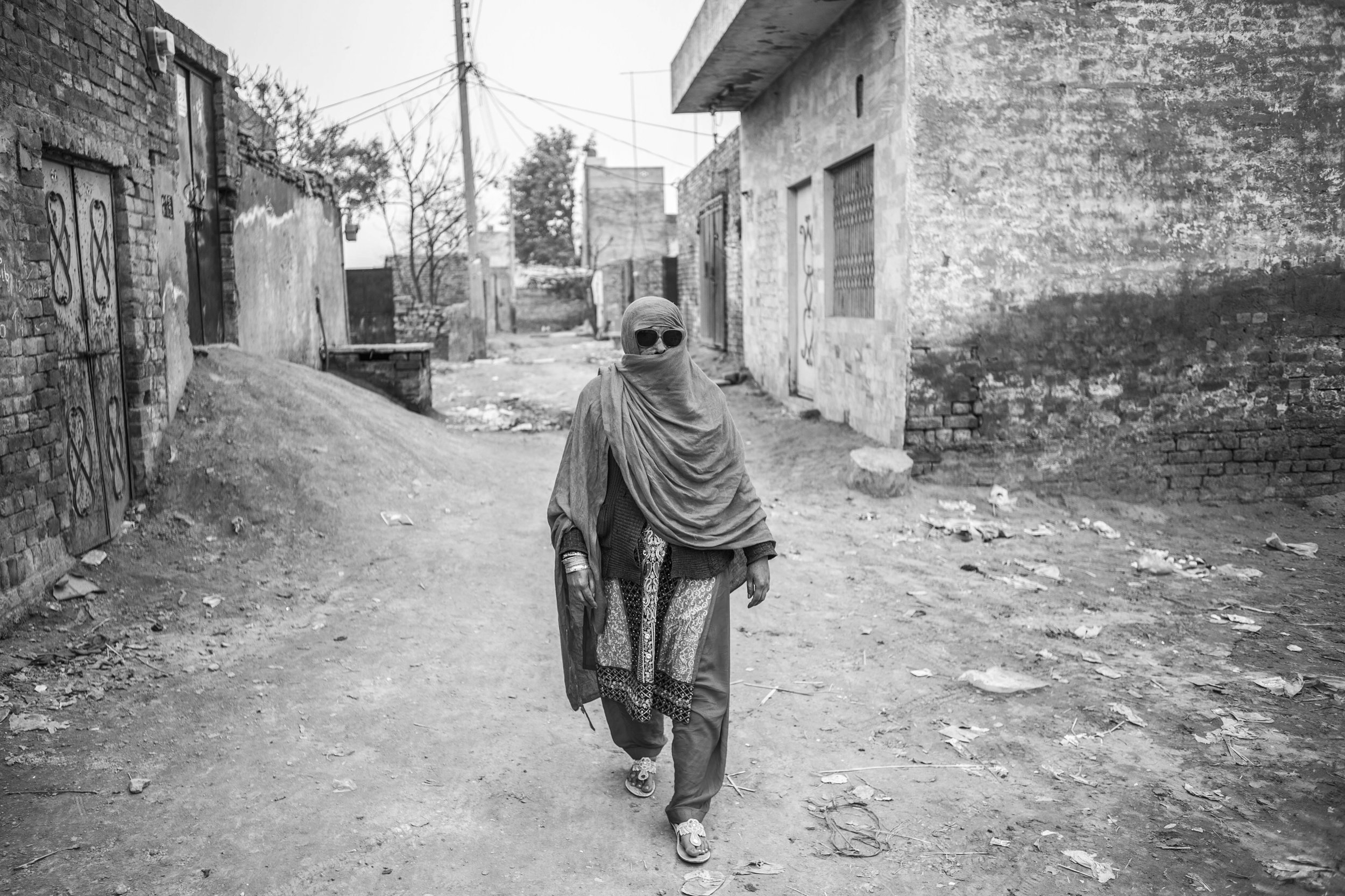  Sarwari Bibi, covers her face when she leaves her residence on Jan. 23, 2016 in Lahore, Pakistan. 