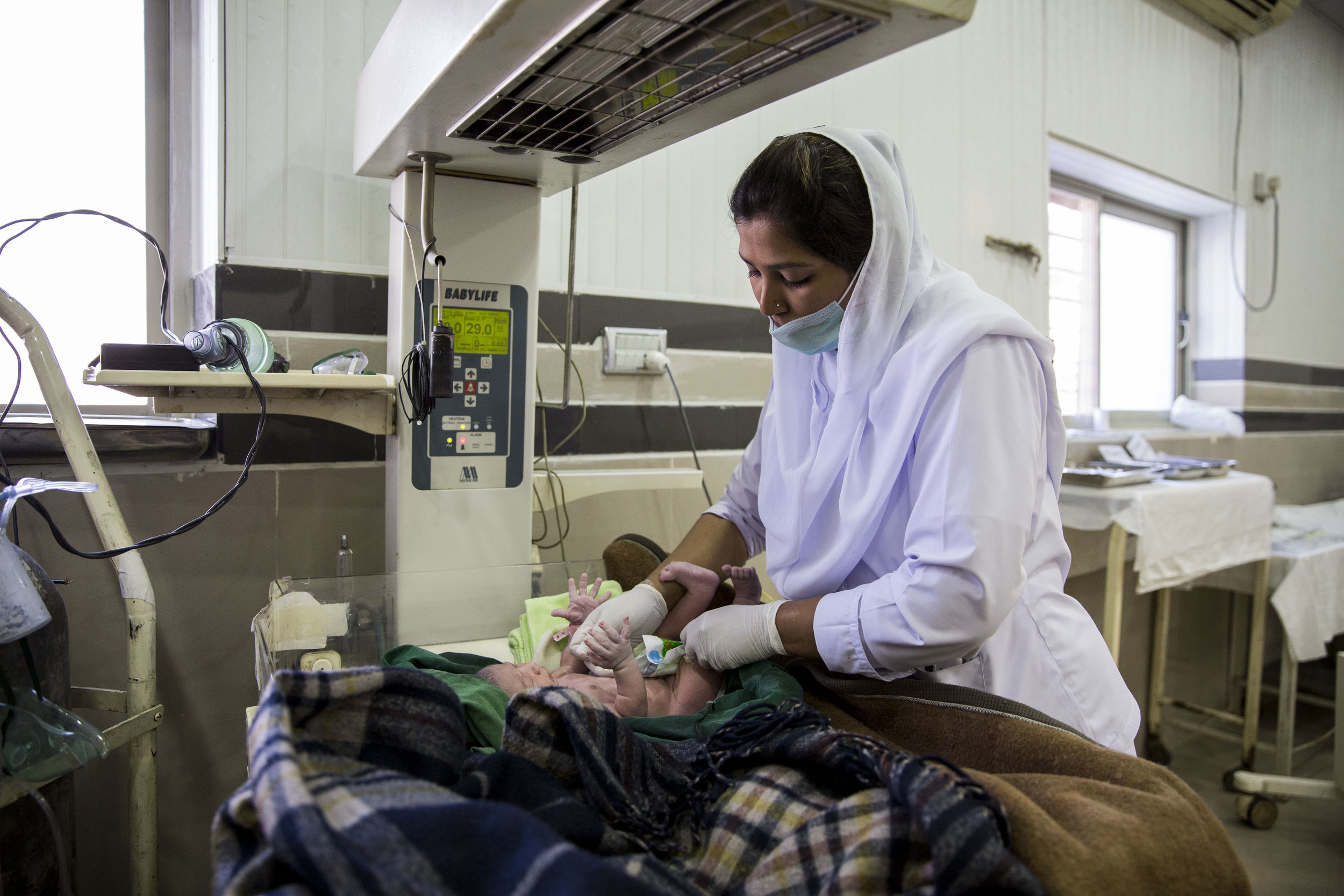  Staff Sehar Kanwal clothes a newborn baby inside the labour room. 