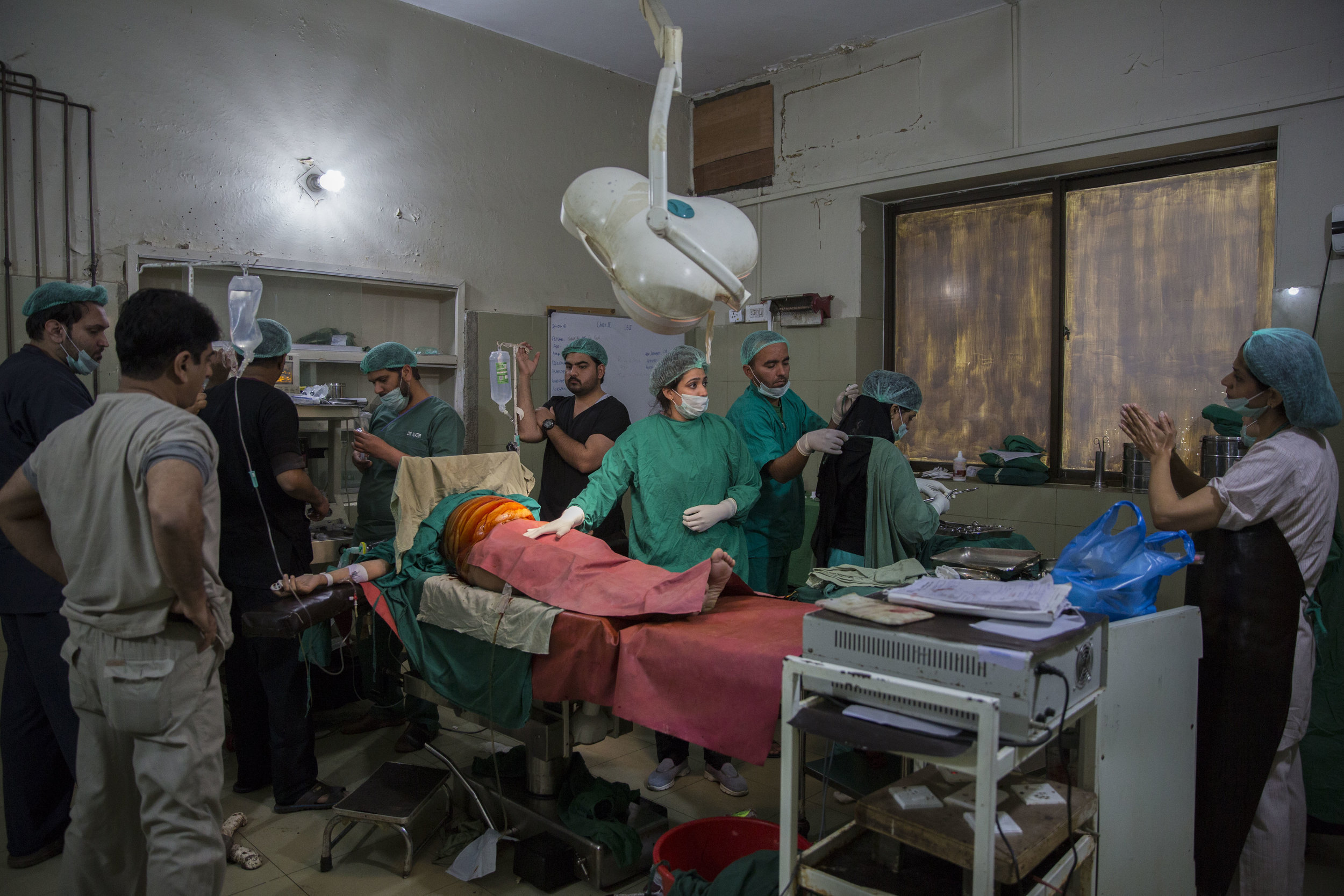  Dr. Sadia Khan along with her team of doctors and technicians prepare Nosheela for a C-section, who is a suspected case of postpartum haemorrhaging. 