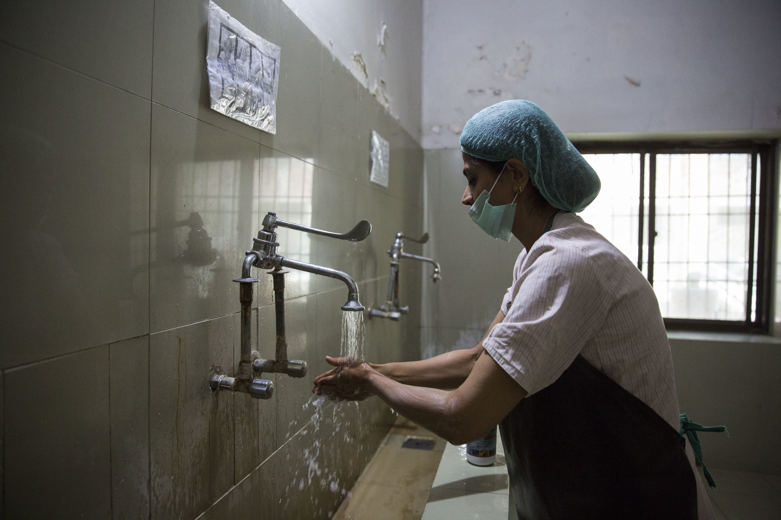  Dr. Sadia Khan washes her hands before entering the operation theatre. 