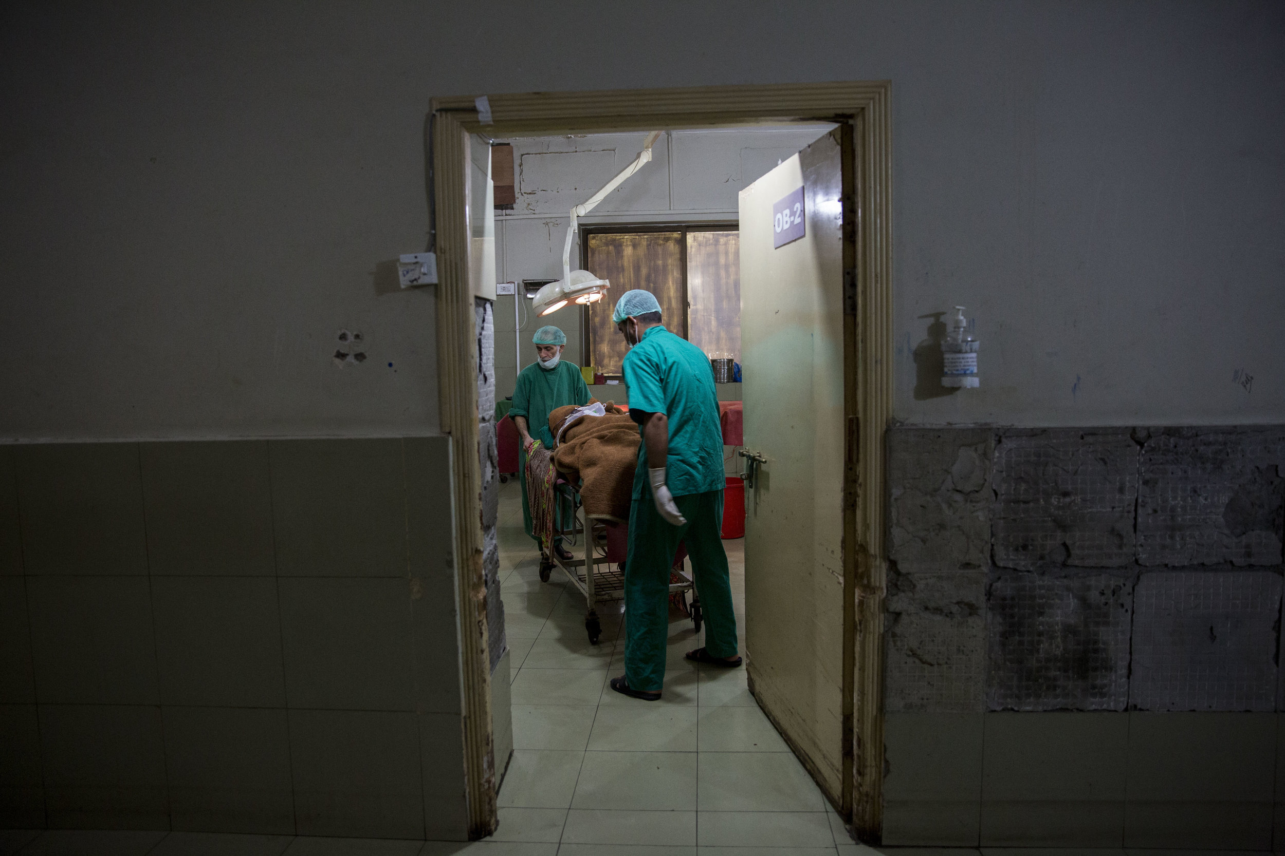  Staff inside the operation theatre prepares to move Nosheela to the high dependency unit after her surgery. 