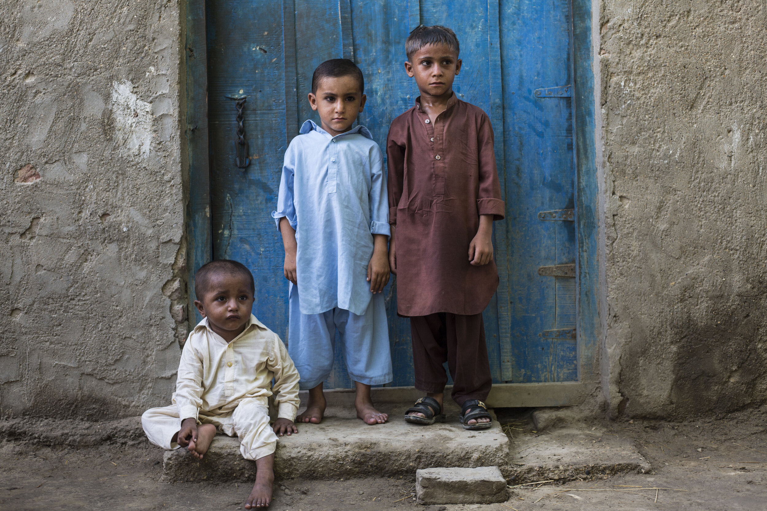 Waqar Ali, 3-year-old sits on the floor along with Abdullah Khan, 5-year-old (left) and Zeeshan Ali, 6-year-old (right) who have all been diagnosed with HIV in Subhani Shar village, around 8 km from Ratodero on July 25, 2019 in Sind, Pakistan.  