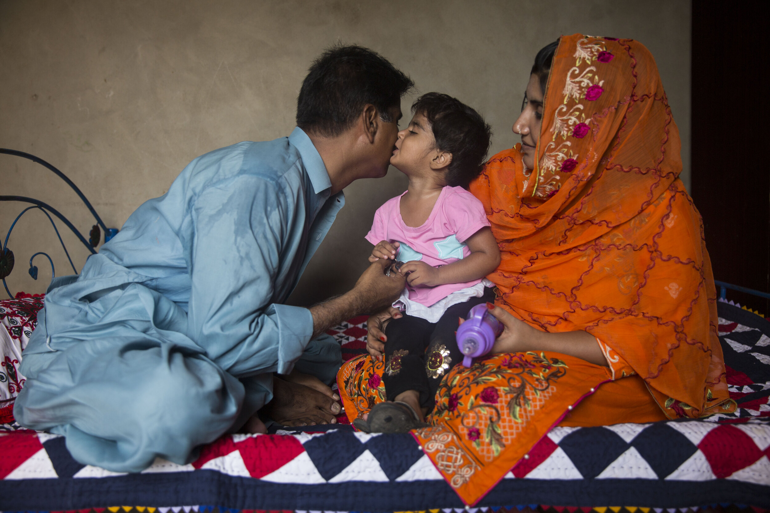  2-year-old Rida Batool who has been diagnosed with HIV along with her parents at their residence on July 24, 2019 in Ratodero, Sind, Pakistan. 