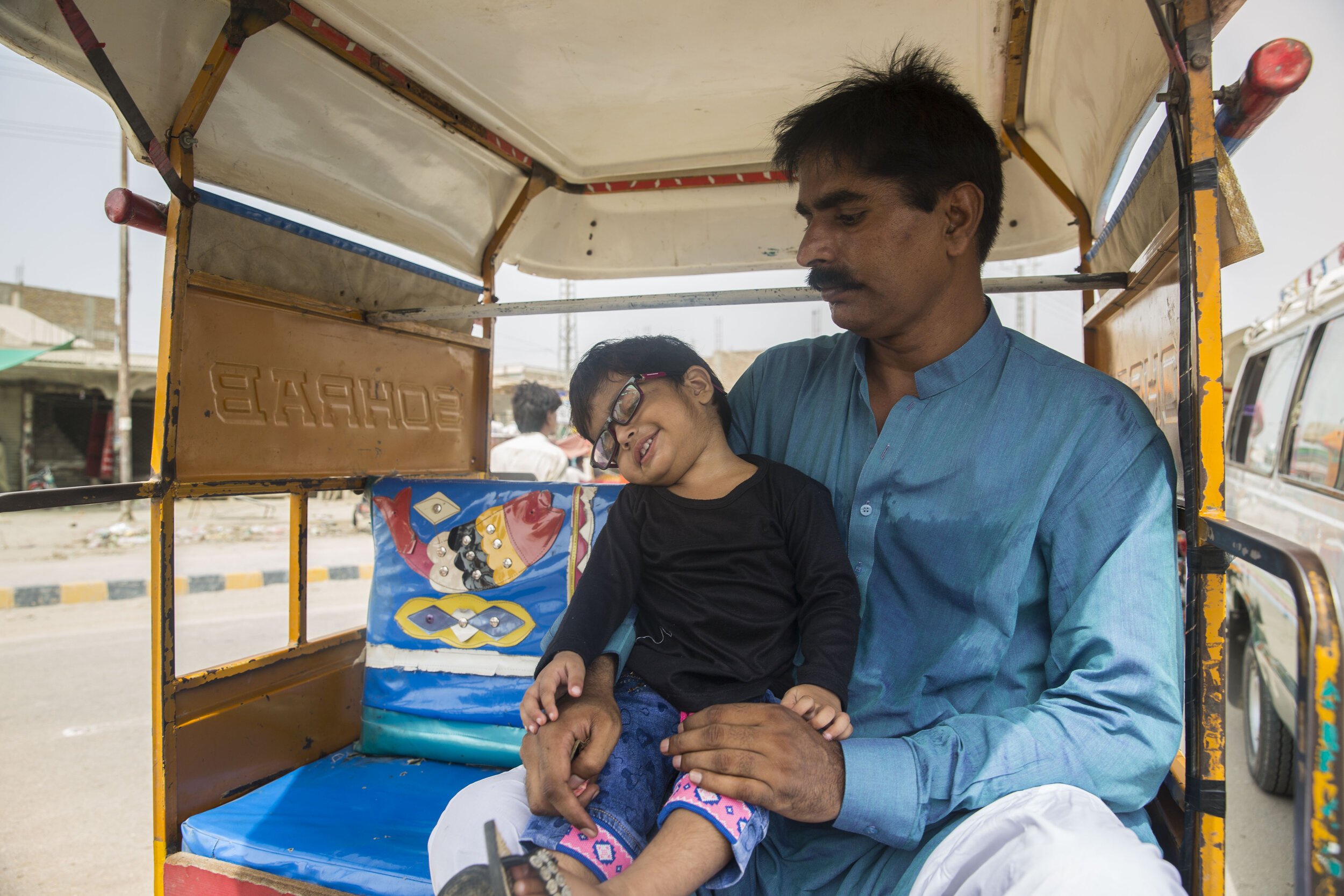  2-year-old Rida Batool who has been diagnosed with HIV along with her father Gulbahar Sheikh reaches Larkana for her medical test after a 30 km journey and takes a rickshaw for another 10 km on July 26, 2019 in Larkana, Sind, Pakistan. 
