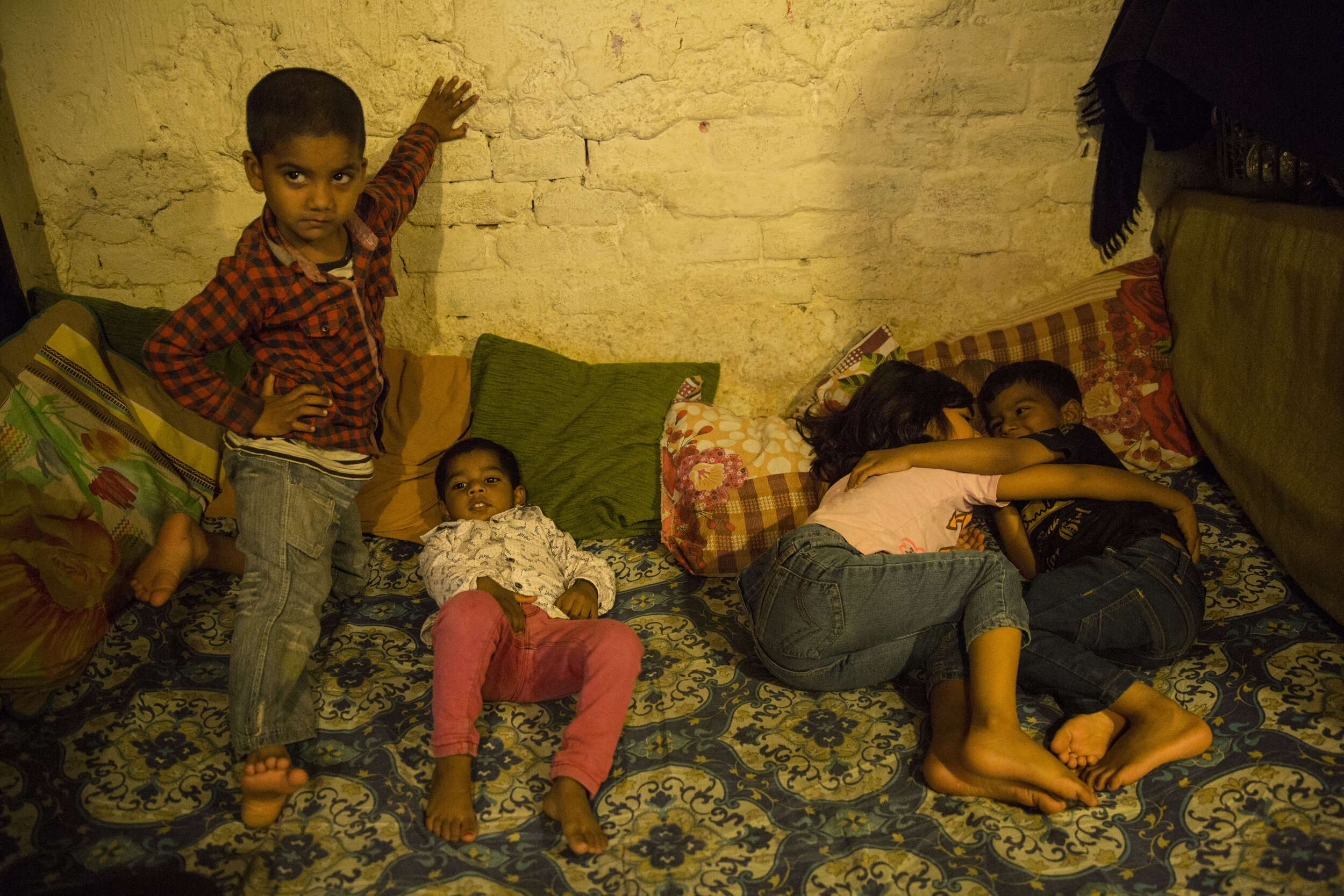  5-year-old Yushya (left) and 2-year-old Cynthia (right) along with their cousins on their bed during the lockdown. 