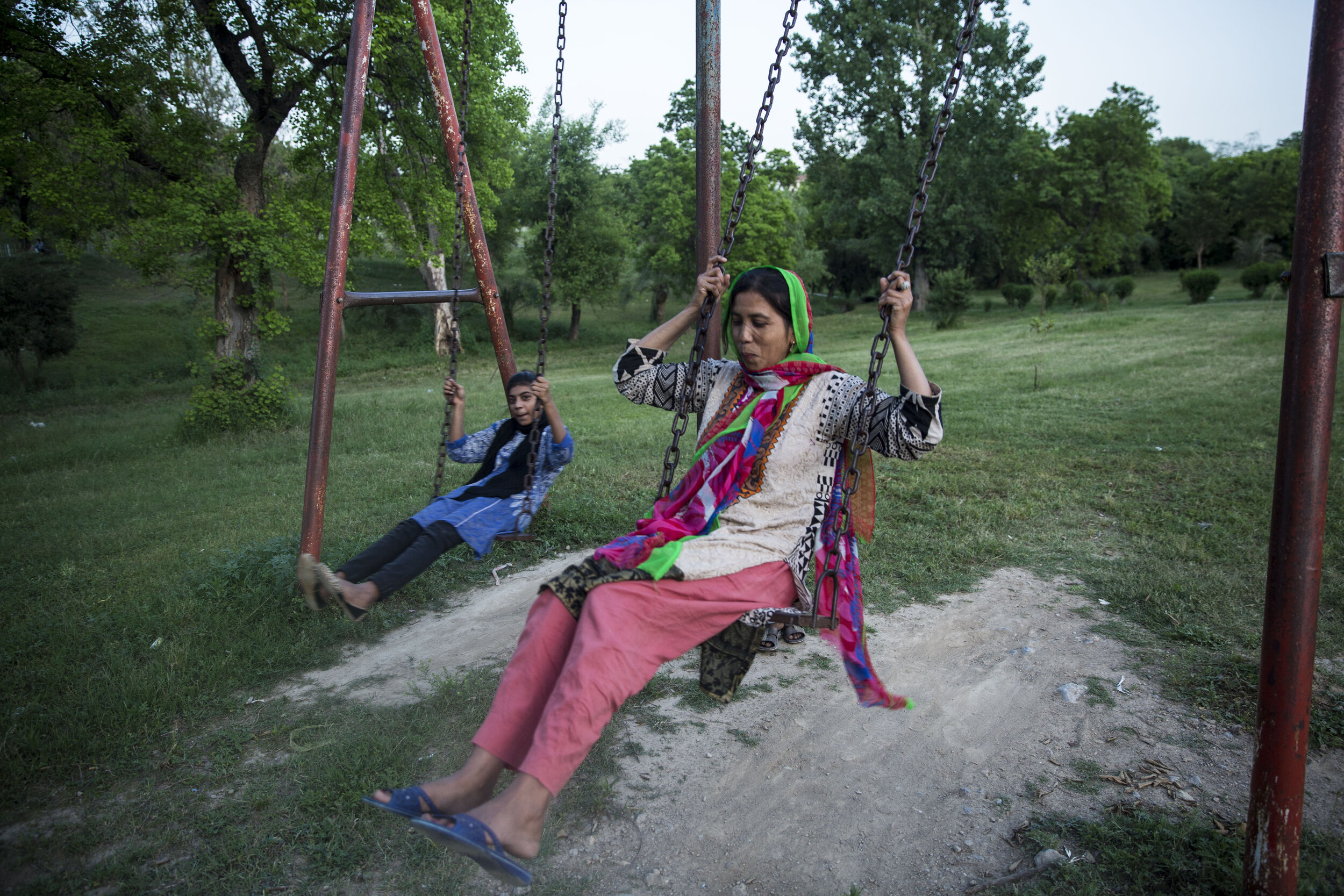  Ishrat Arif sits on a swing in the park, which not only serves as a respite for children under the lockdown but for adults as well. 