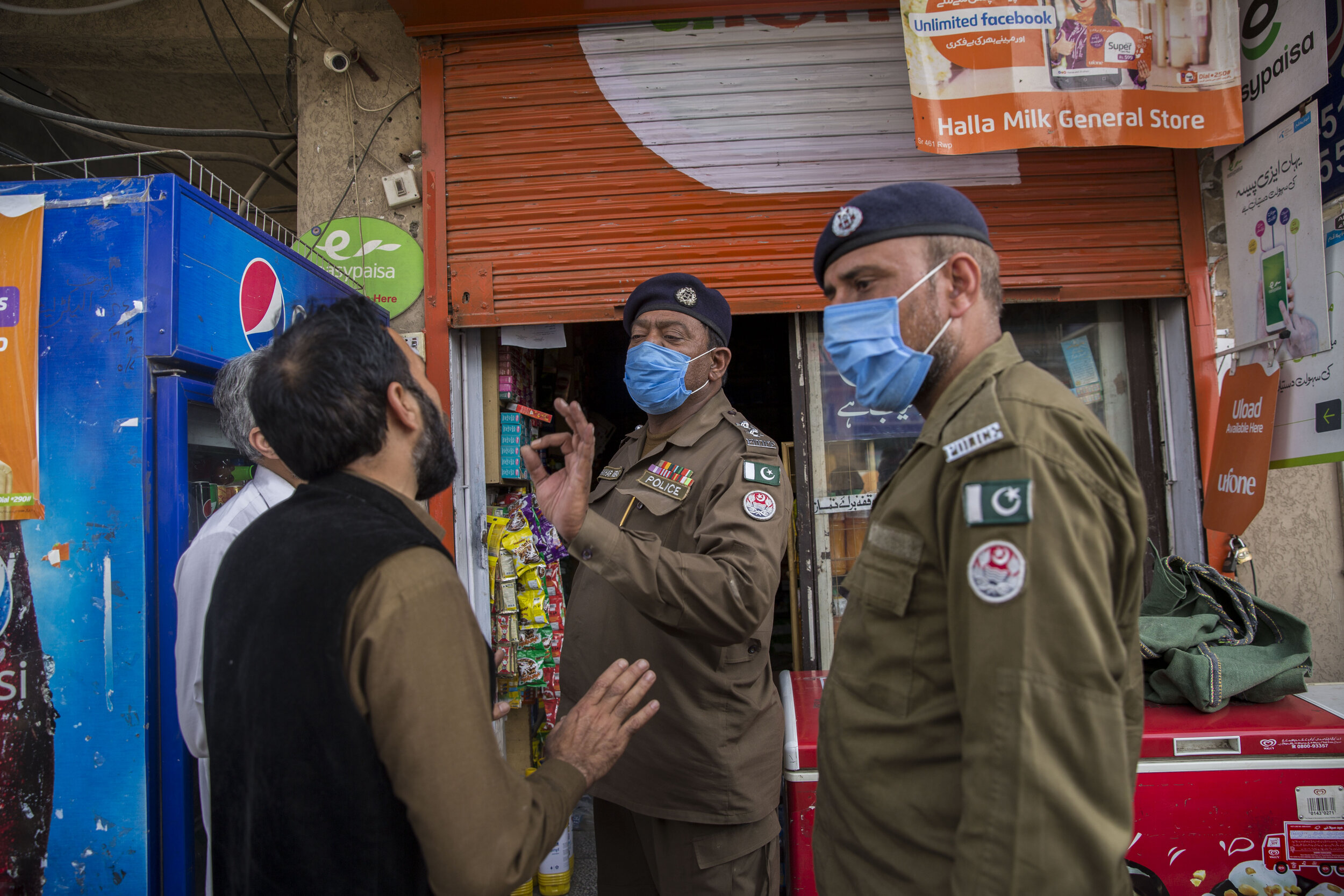  A police inspector tells the shopkeepers to close down and abide by the 5 p.m. curfew to shutdown during the lockdown. 