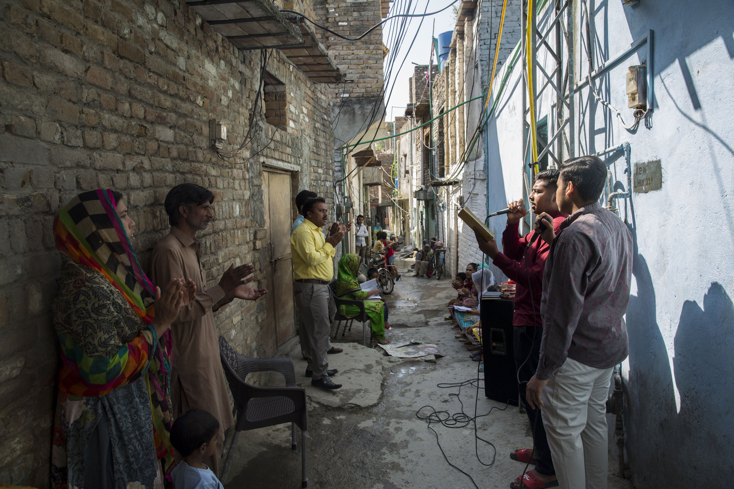  Arif Masih and his wife attend the Sunday mass in one of the streets in their neighbourhood as Churches remain closed during the pandemic. 