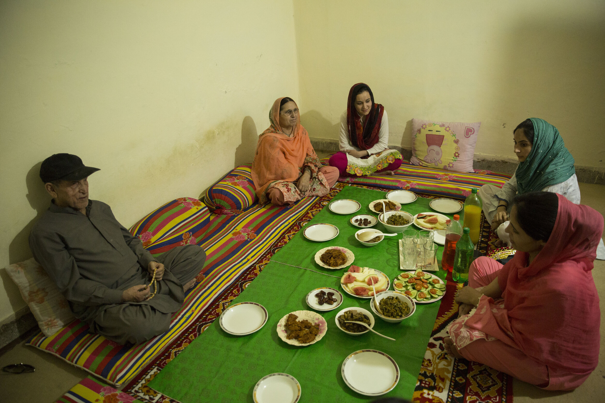  Nusrat Bibi, sits down with her family and waits to open her fast during Iftar. She is grateful that she can still put food on the table during the pandemic. 